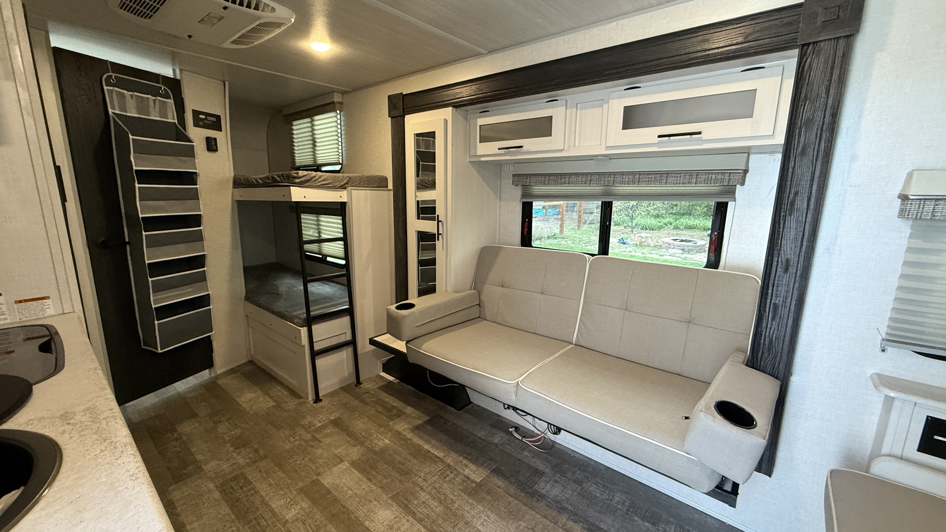 RV rental interior featuring bunk beds, a sofa, kitchen counter, and ample storage for comfortable travel.. R-Pod R-Pod Trailer 2022