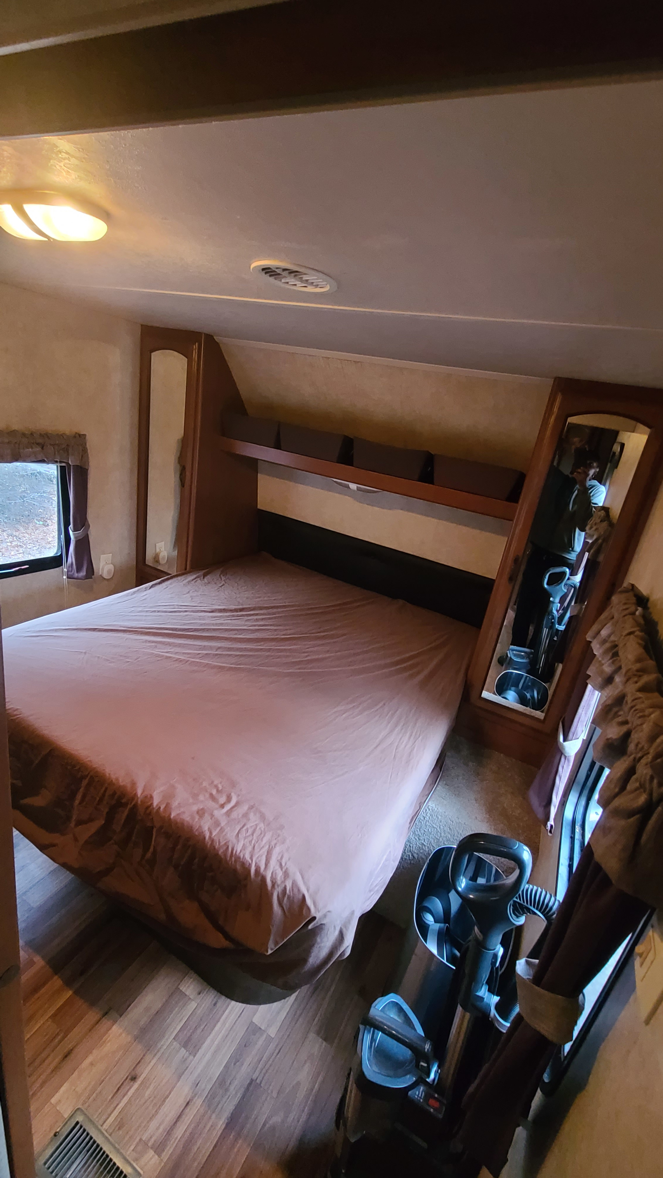 RV rental bedroom with a large bed, built-in storage, and compact layout. Ideal for comfortable mobile travel.. Coachmen salem 2013