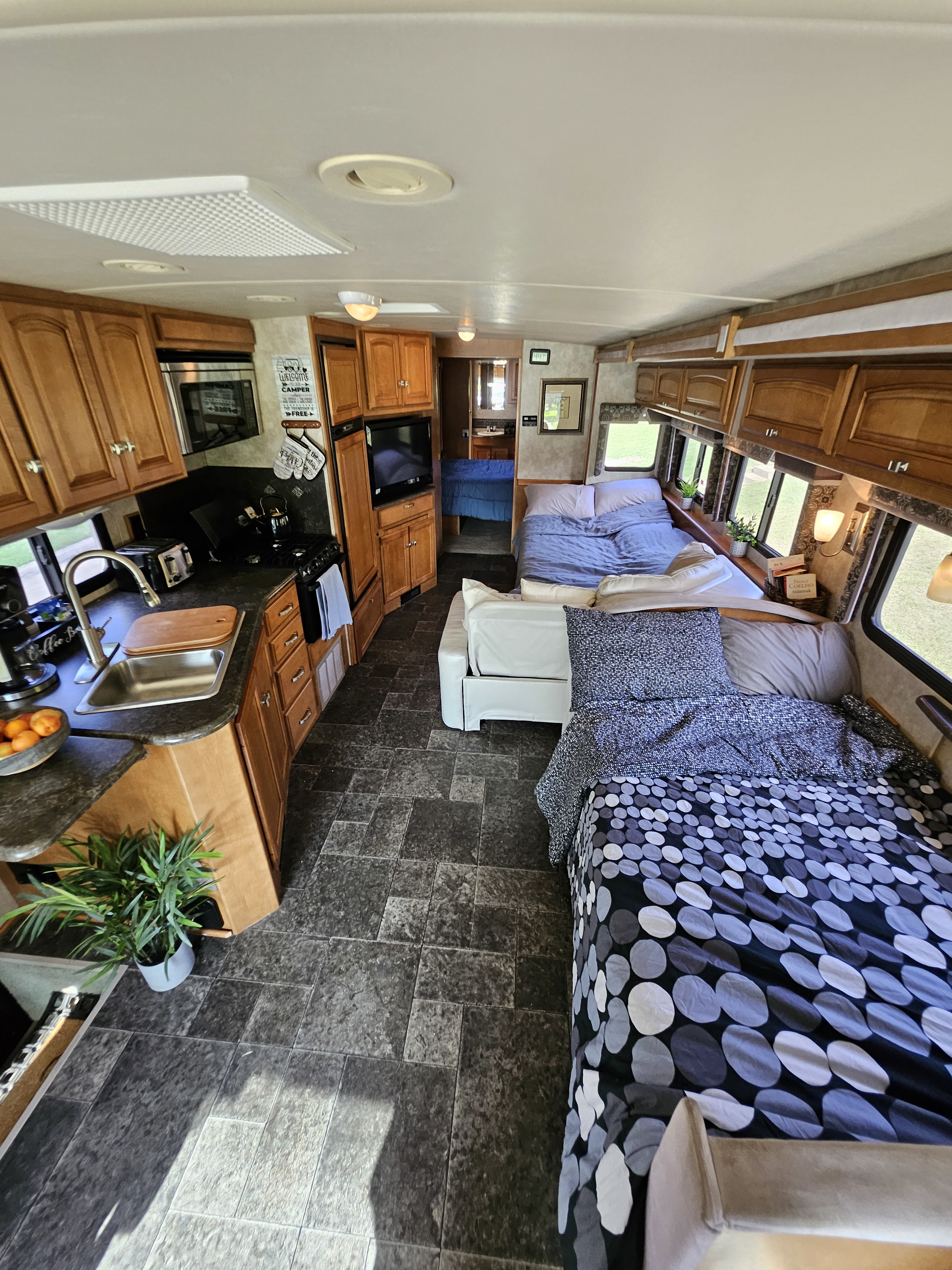 Your next RV rental awaits! See the full kitchen, comfortable bedrooms, and cozy living area inside this spacious RV.. Winnebago Vista 2013
