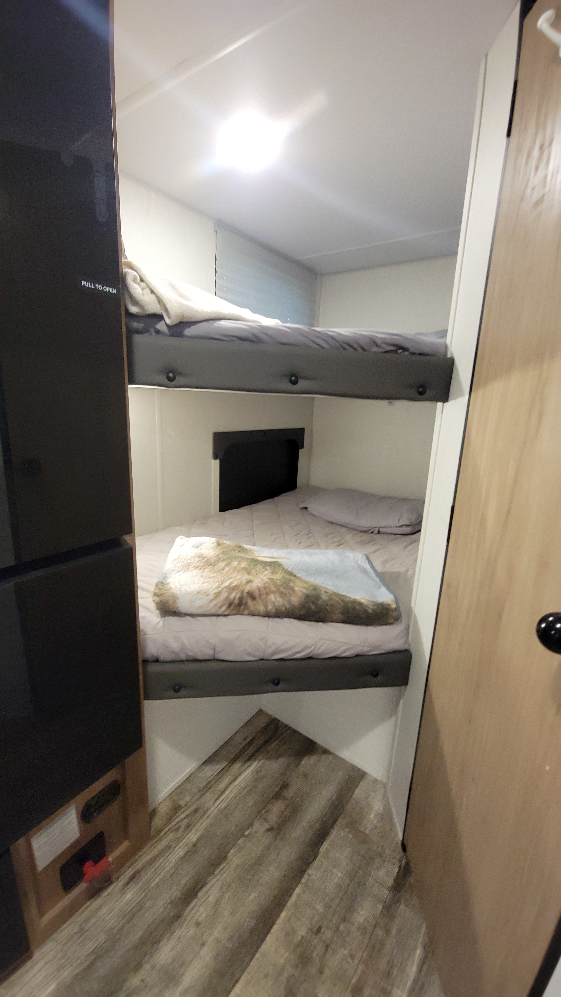 RV rental: Bunk beds in a camper interior. Two stacked sleeping areas with blankets and pillows for compact comfort.. Forest River Cherokee Wolf Pup 2024
