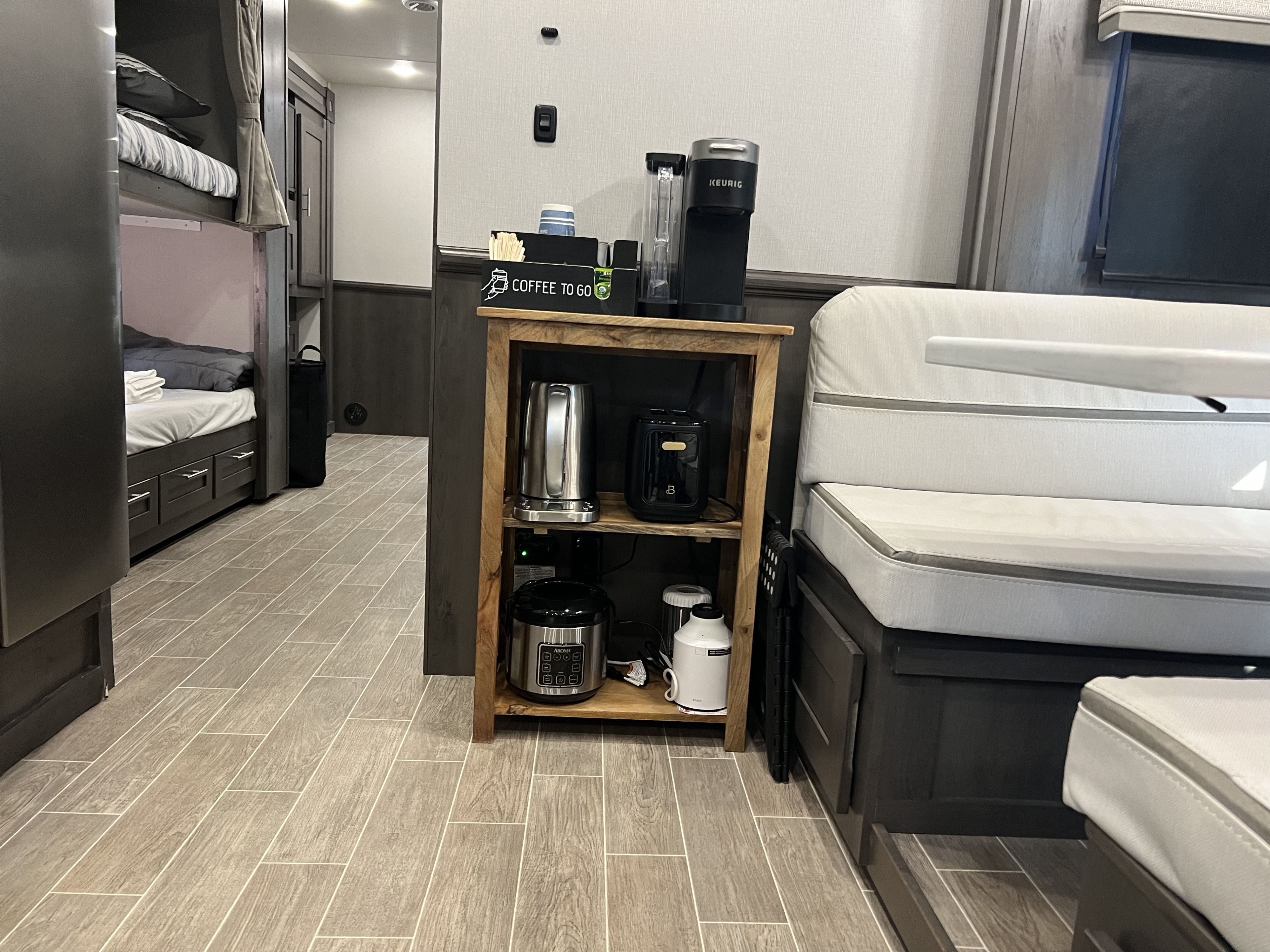 Inside an RV rental: bunk beds, a coffee station with Keurig, and diverse kitchen appliances make for a homey, functional space.. Georgetown GT5 2022