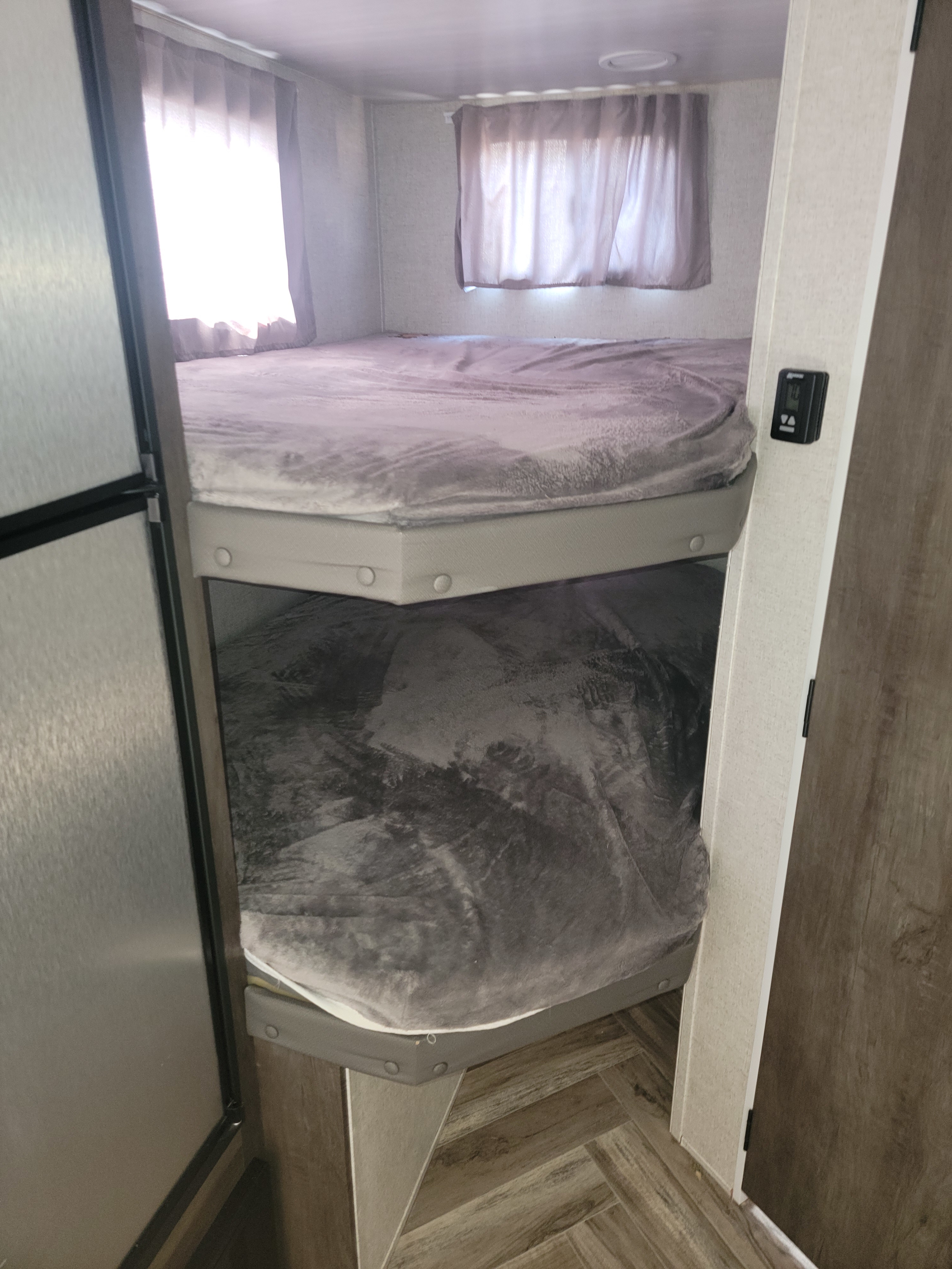 Cozy bunk beds inside an RV rental, offering comfortable sleeping arrangements for your family's travel adventures.. Forest River Salem Cruise Lite 2021