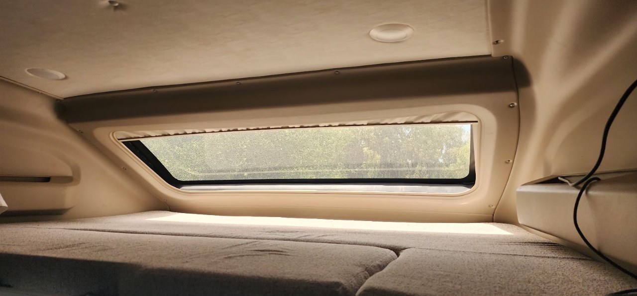 Cozy RV rental sleeping bunk with a large window view of trees. Great for travel.. Jayco Melbourne Prestige 2022