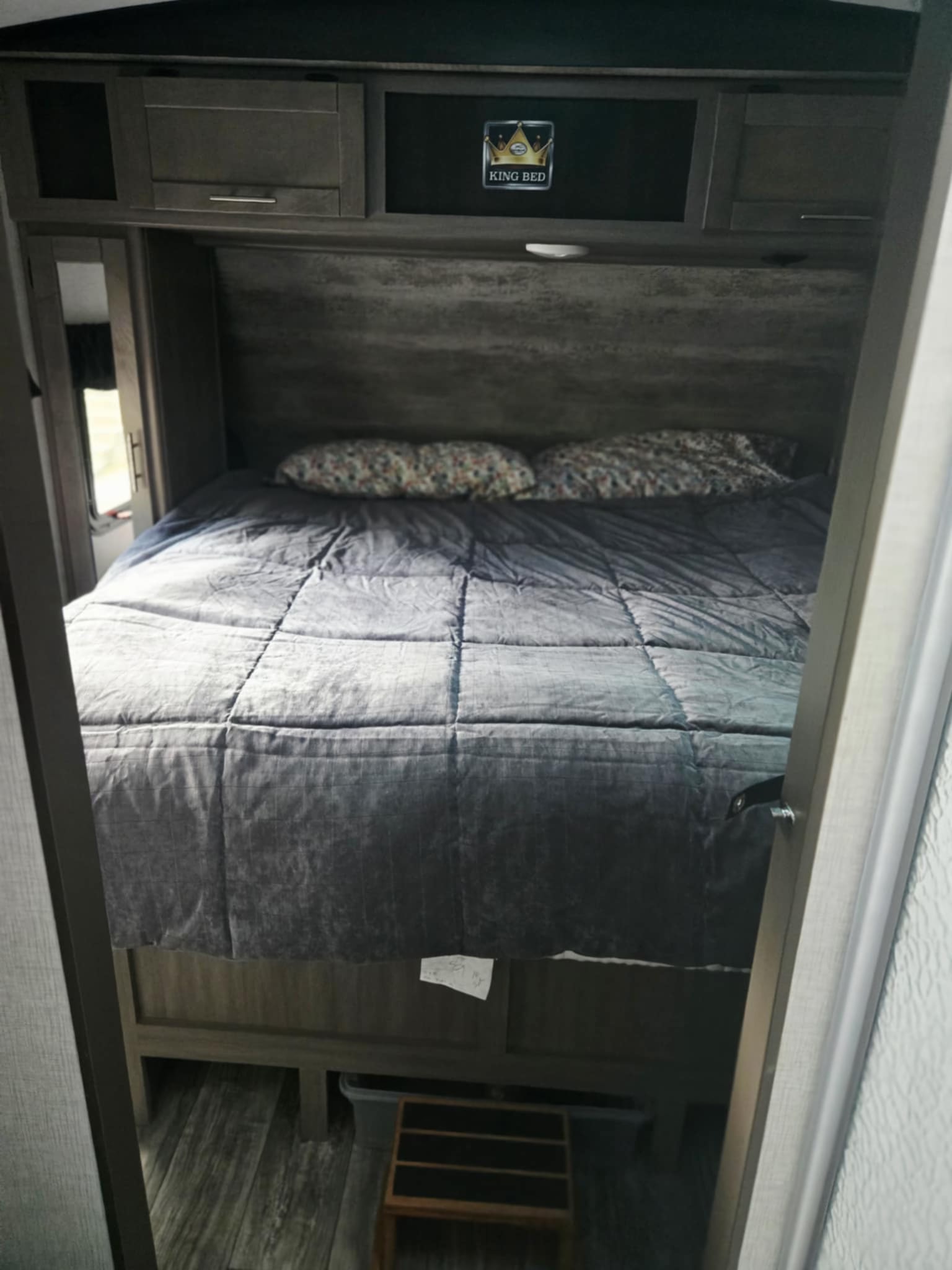 Spacious RV rental bedroom featuring a comfortable king bed and overhead storage for a cozy travel experience.. Crossroads RV Sunset Trail Super Lite 2021