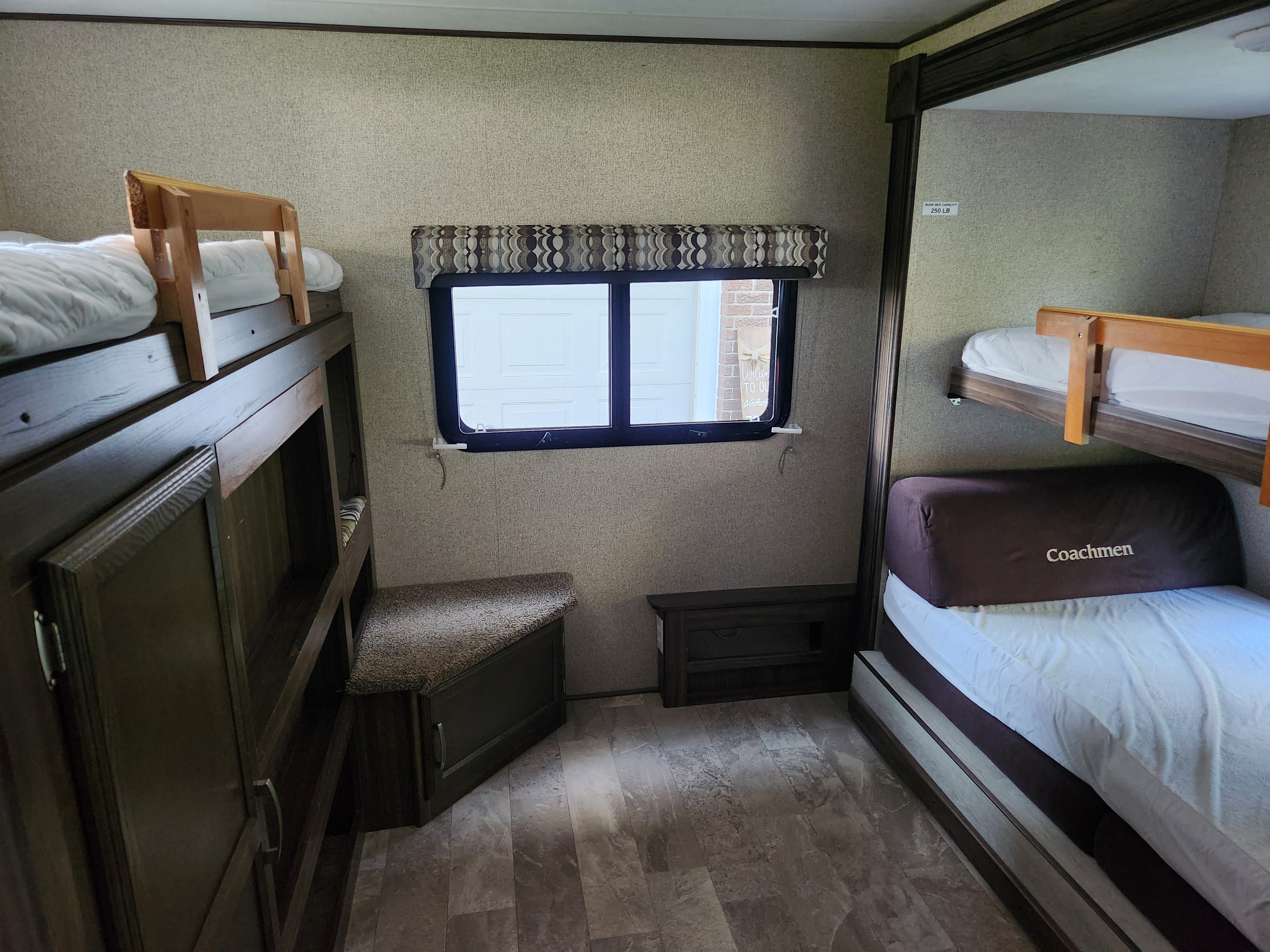 Spacious RV rental bunkhouse interior. Features multiple bunk beds and storage, ideal for families.. Coachmen Apex 2018