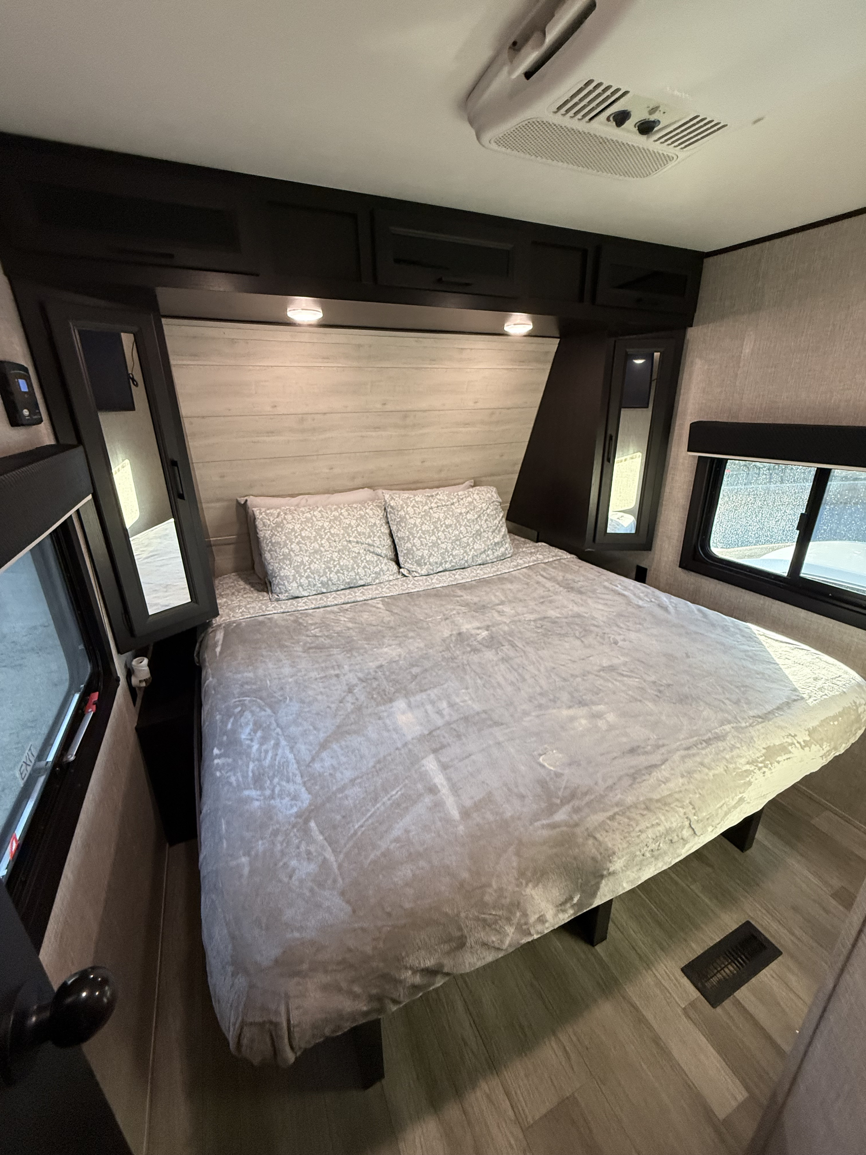 RV rental bedroom with a comfy queen bed, mirrored closets, overhead storage, and AC unit for your travel.. Jayco Jay Flight 2022