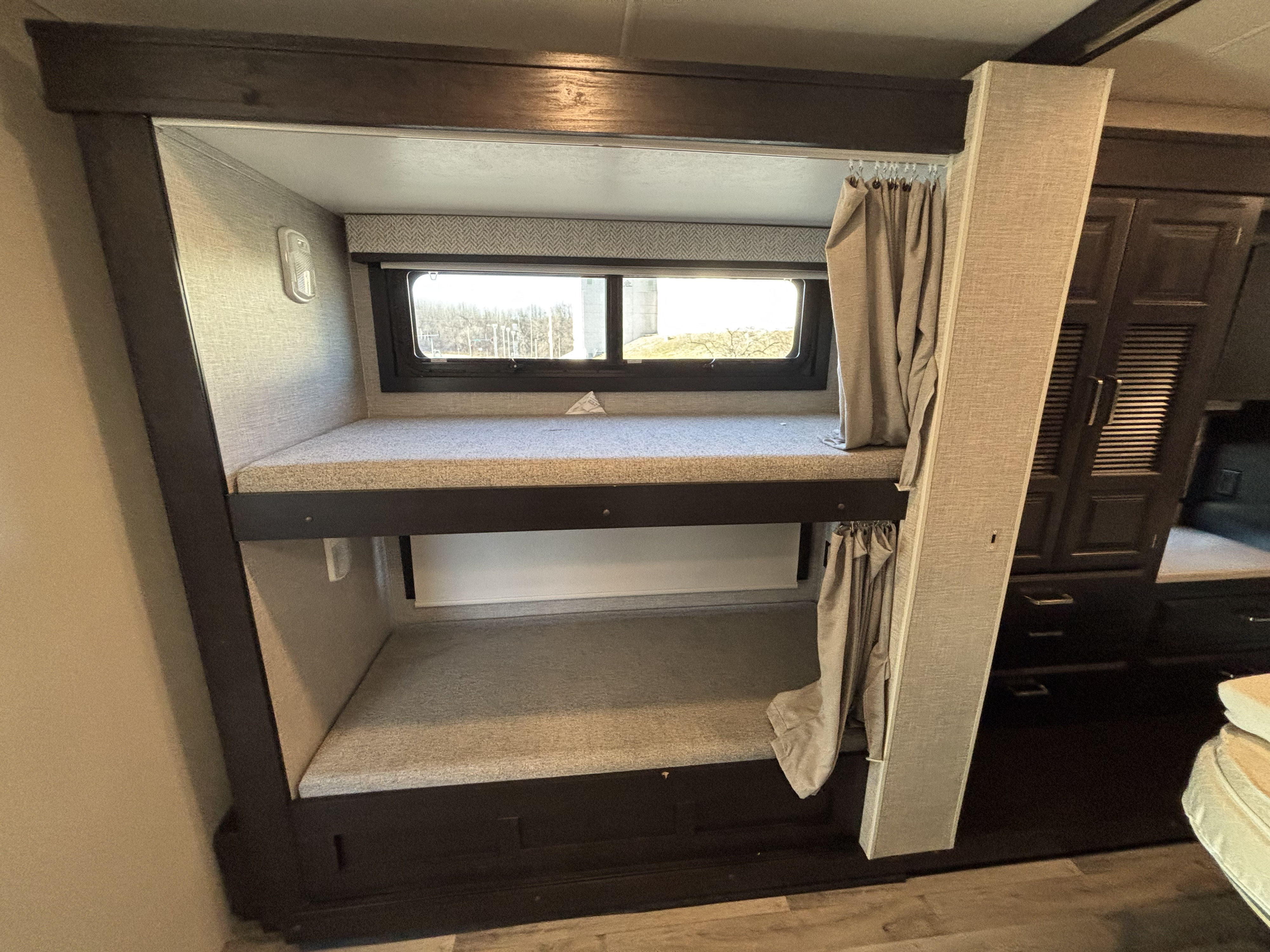 RV rental: comfortable bunk beds with privacy curtains and a window, ideal for extra sleeping space.. Jayco Precept 2023