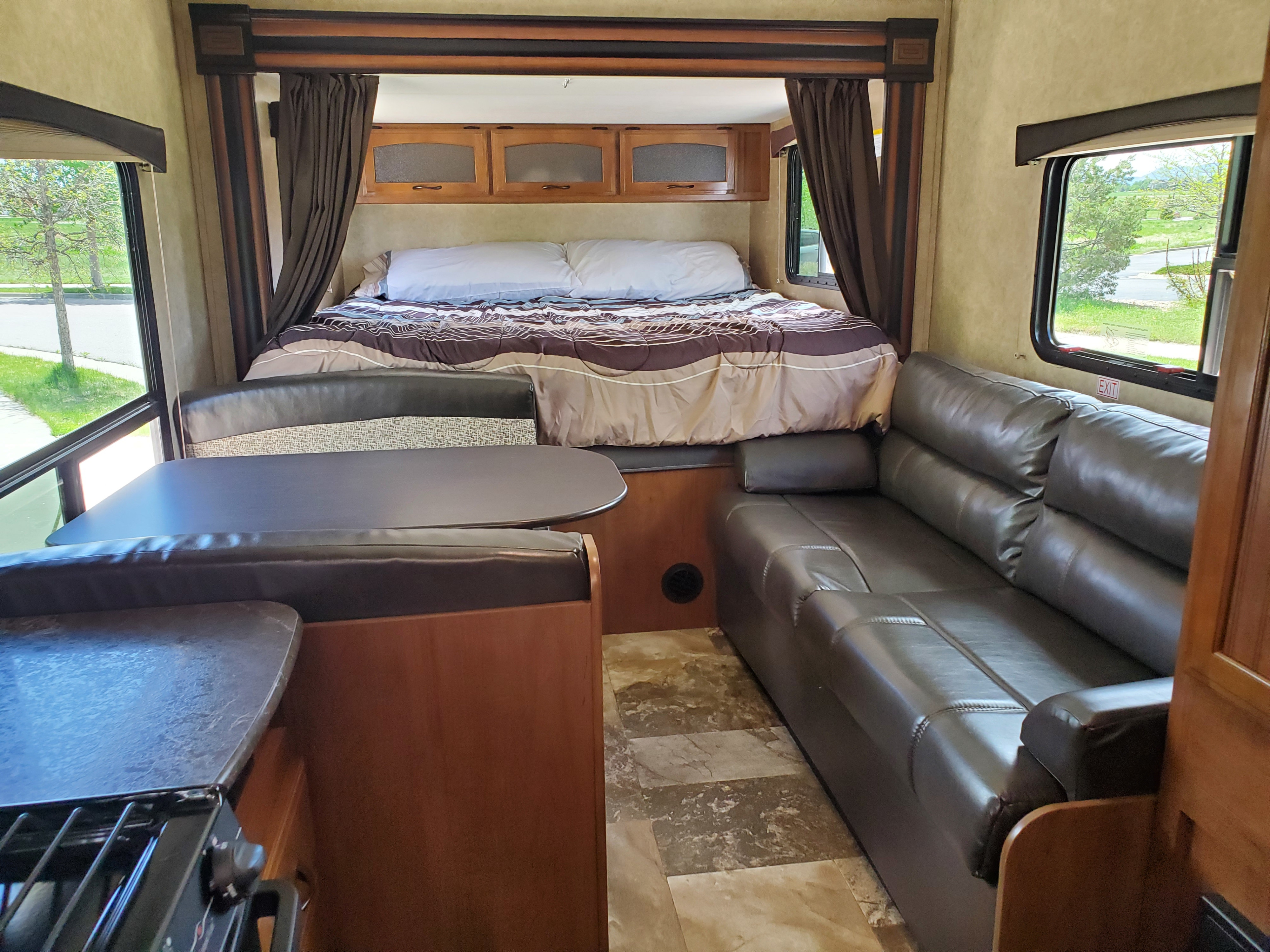 This RV rental features a comfortable bed, dinette, spacious sofa, and kitchen counter, ideal for travel.. Jayco Jay Feather 2016