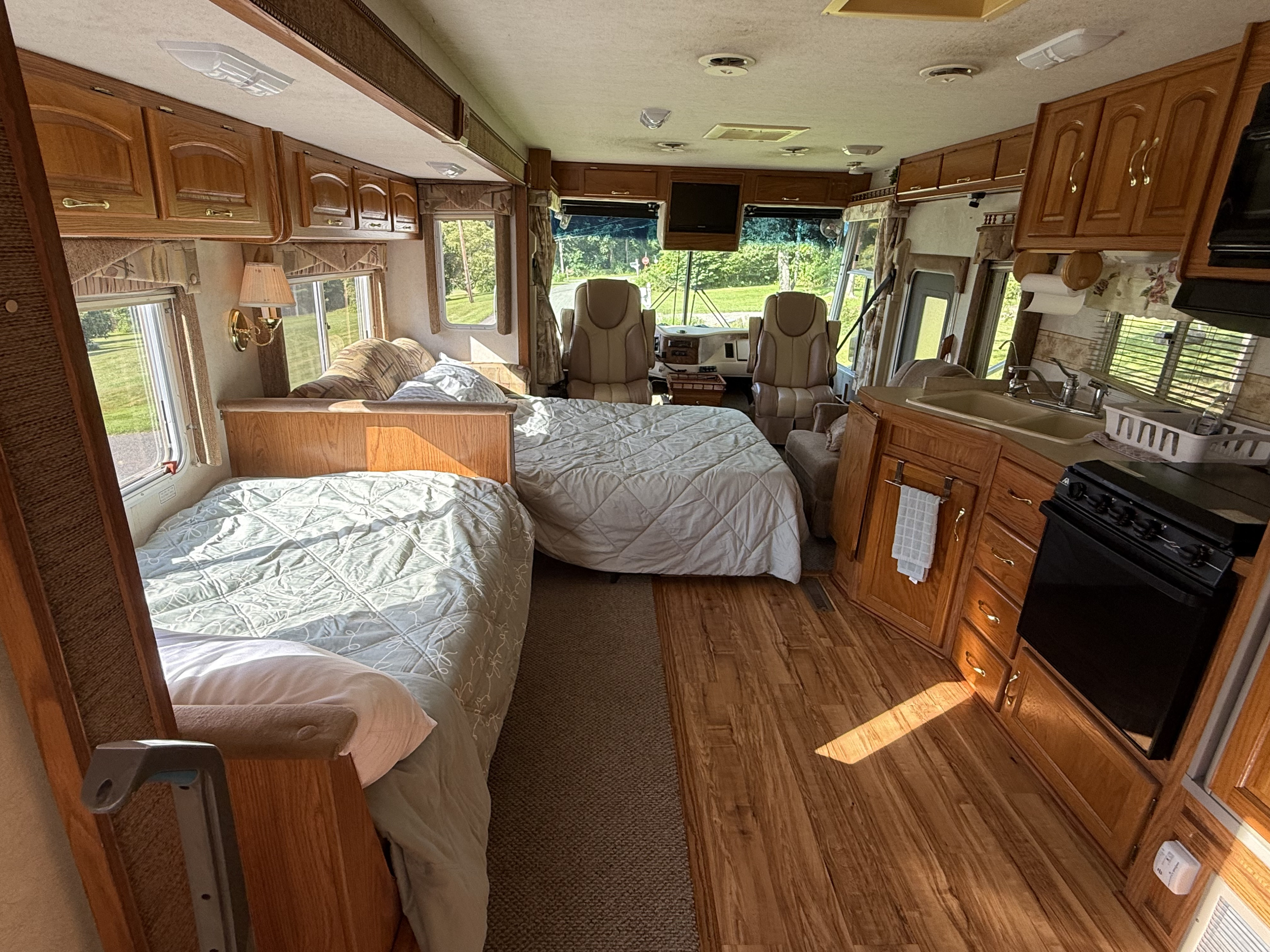 Spacious rv rental interior featuring sleeping areas, a kitchen, and cockpit. Perfect for comfortable road trips.. Damon Corporation Challenger 2003