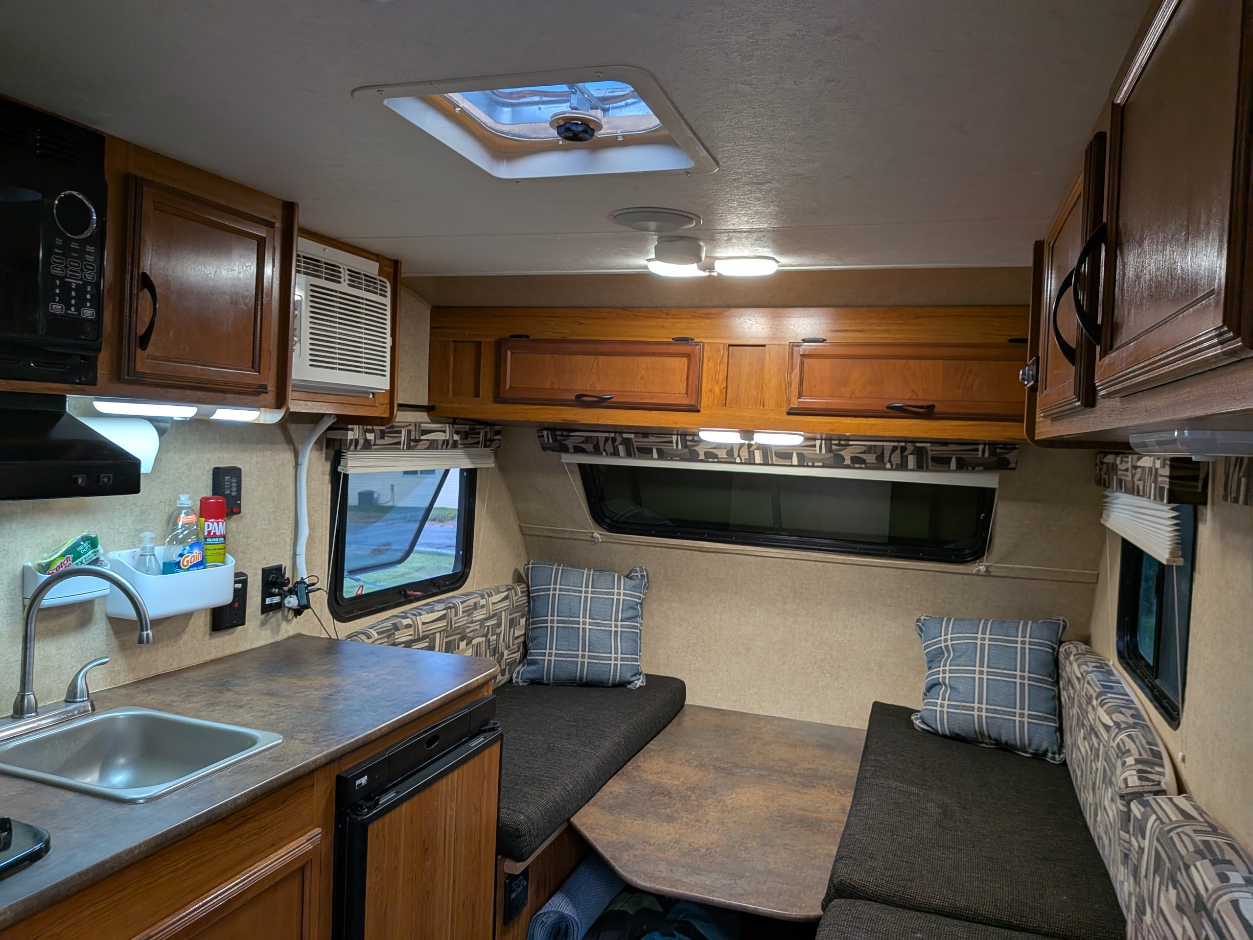 Cozy rv rental interior featuring a kitchen, dinette, and convertible sleeping area for comfortable travel.. Starcraft AR-One 2015