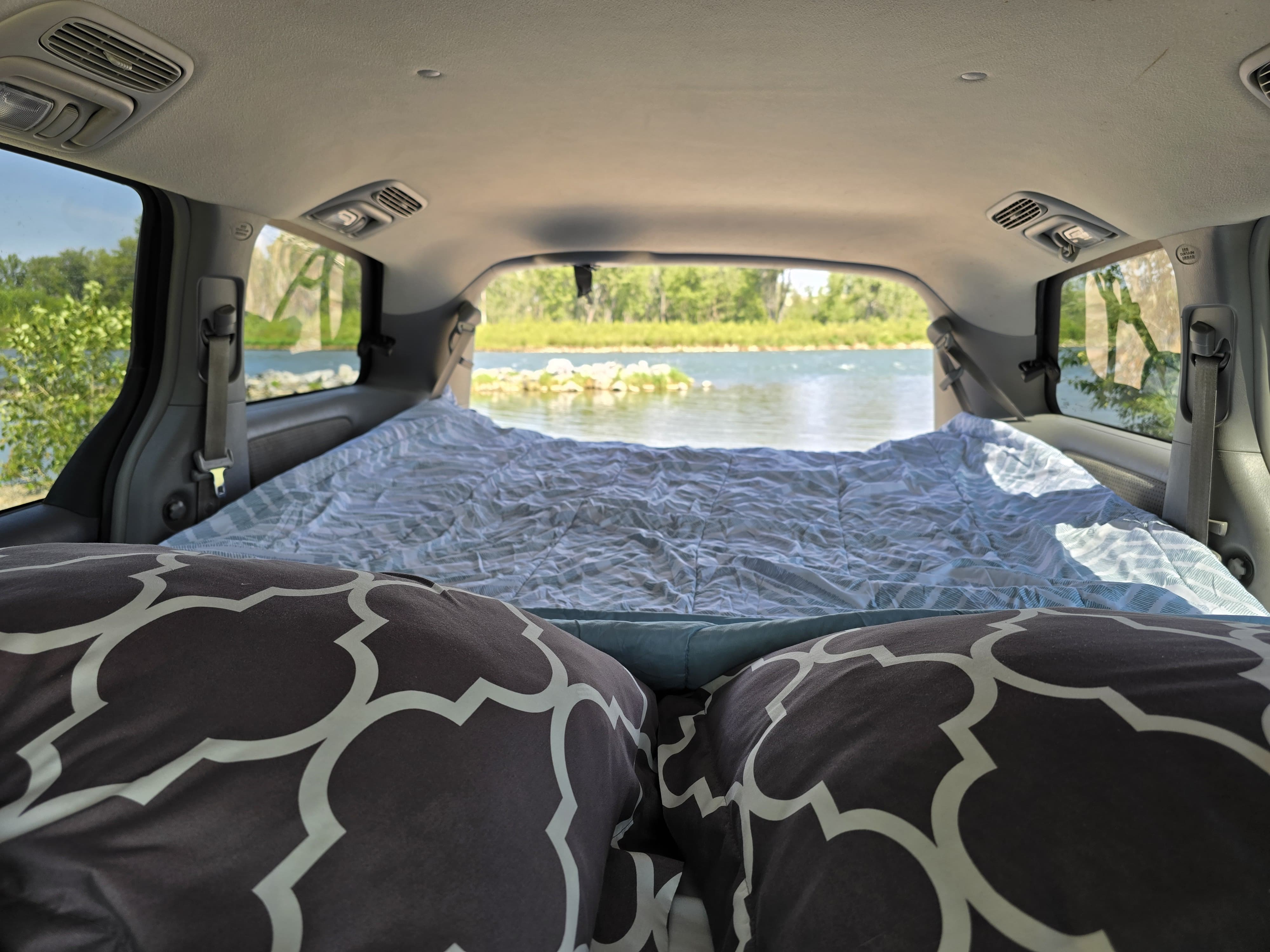 Cozy bed in RV rental (minivan conversion) with river view. Ideal for camping & road trips.. Toyota Sienna 2007