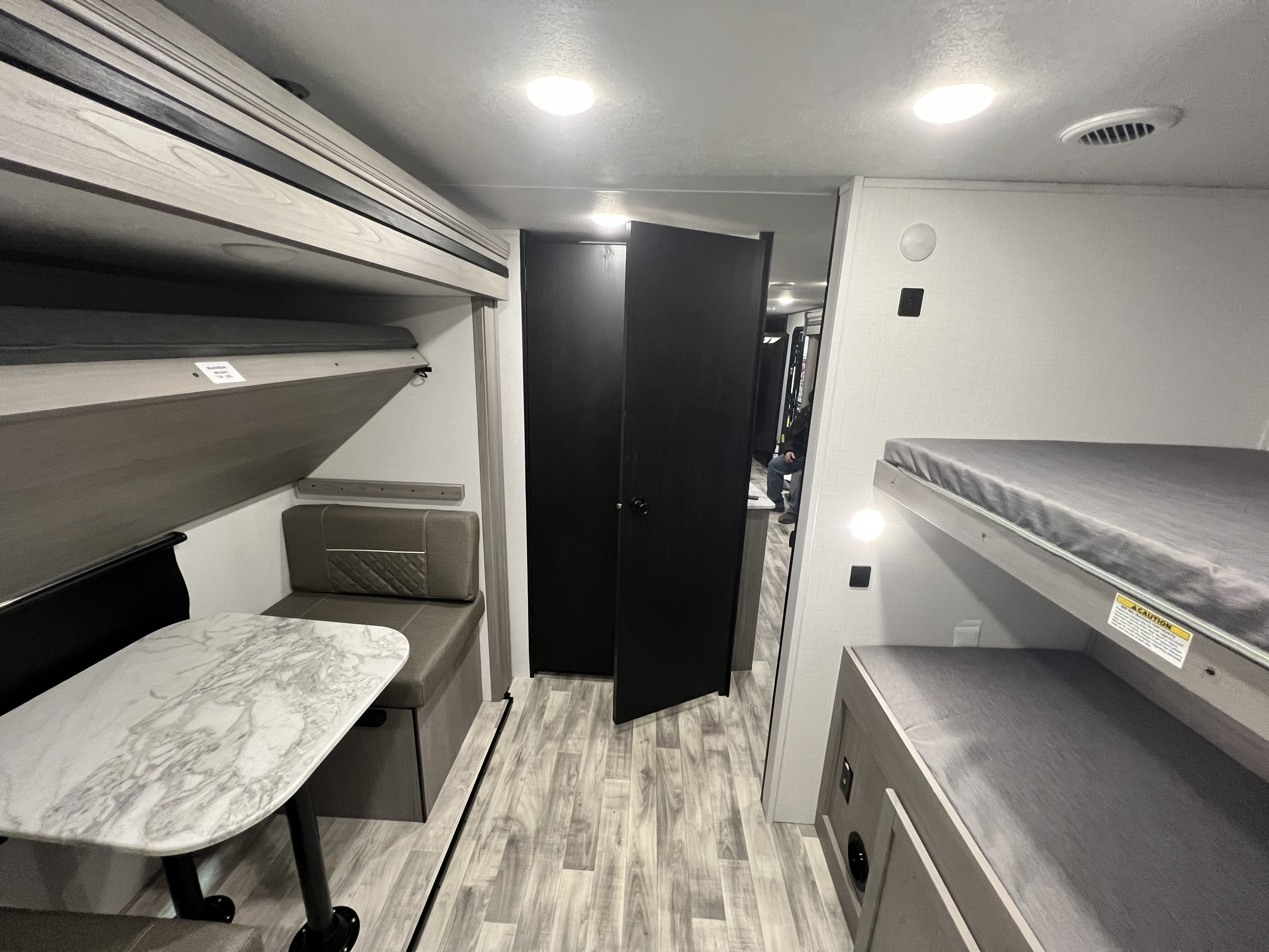 RV rental interior showcasing a dinette with bench seating, stacked bunk beds, and a practical layout.. Dutchmen Kodiak Ultimate 2024