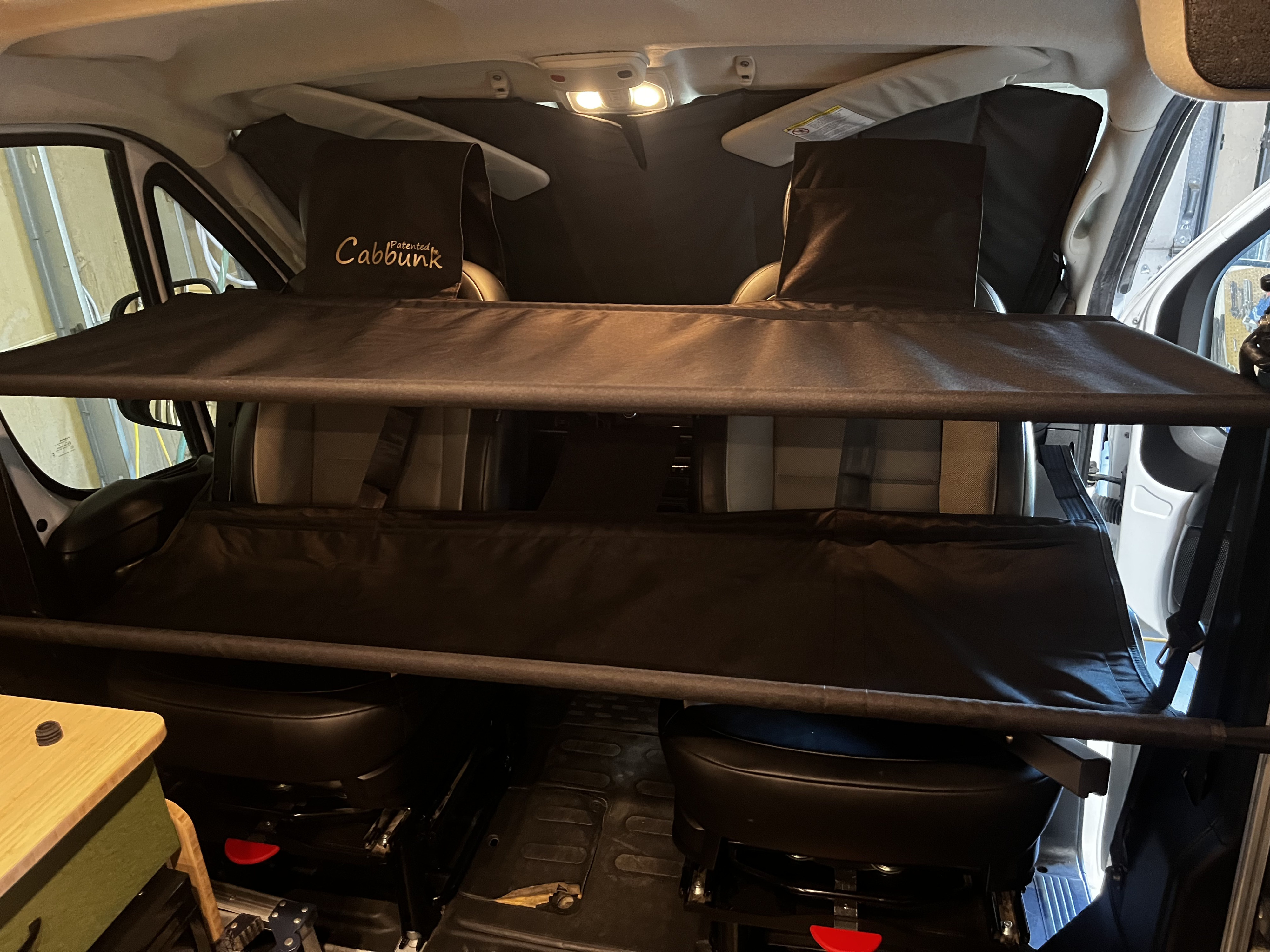 Inside an RV rental, a Cabbunk system offers extra sleeping space in the cab, complete with privacy shades.. Ram Promaster 2023