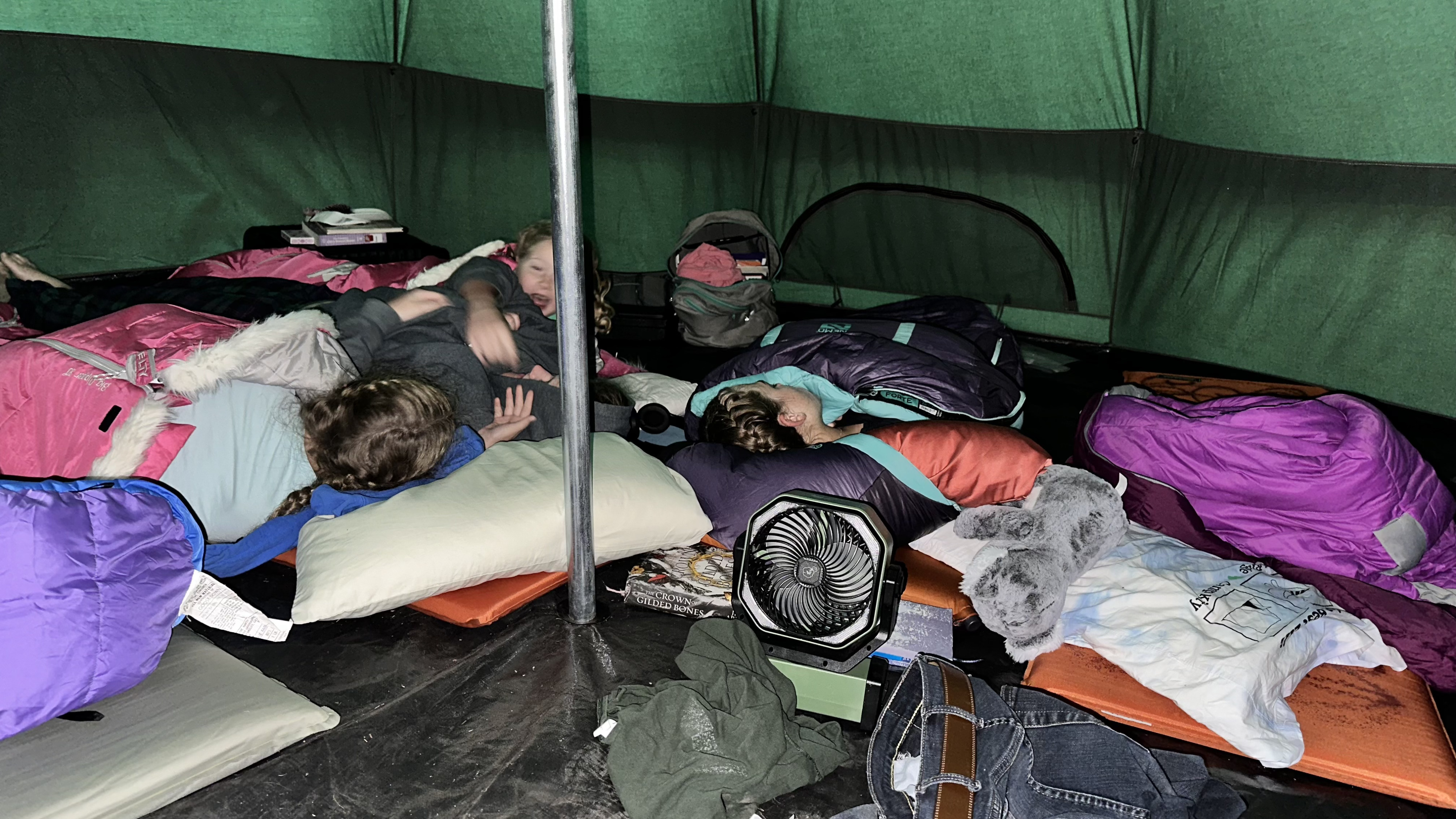 Inside a spacious tent, people sleep comfortably on pads and bags, making for a great rest after an RV rental adventure.. 1FBVU5XG6RKB81847 Ford Transit 350HD AWD 2024