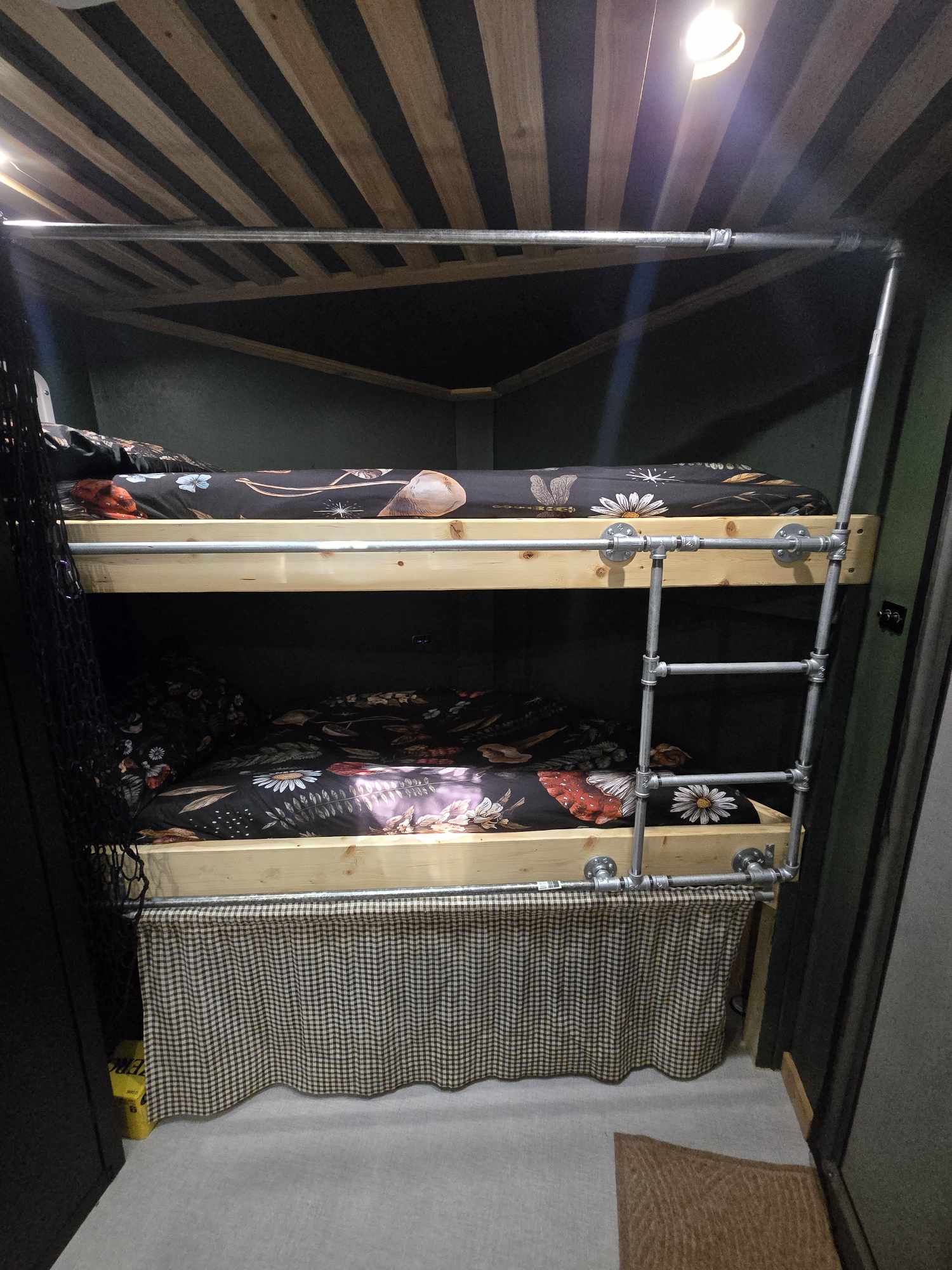 Inside your RV rental, find comfortable bunk beds with a sturdy pipe ladder and cheerful floral sheets.. Action 7x14 Aluminum tandem axel 2025