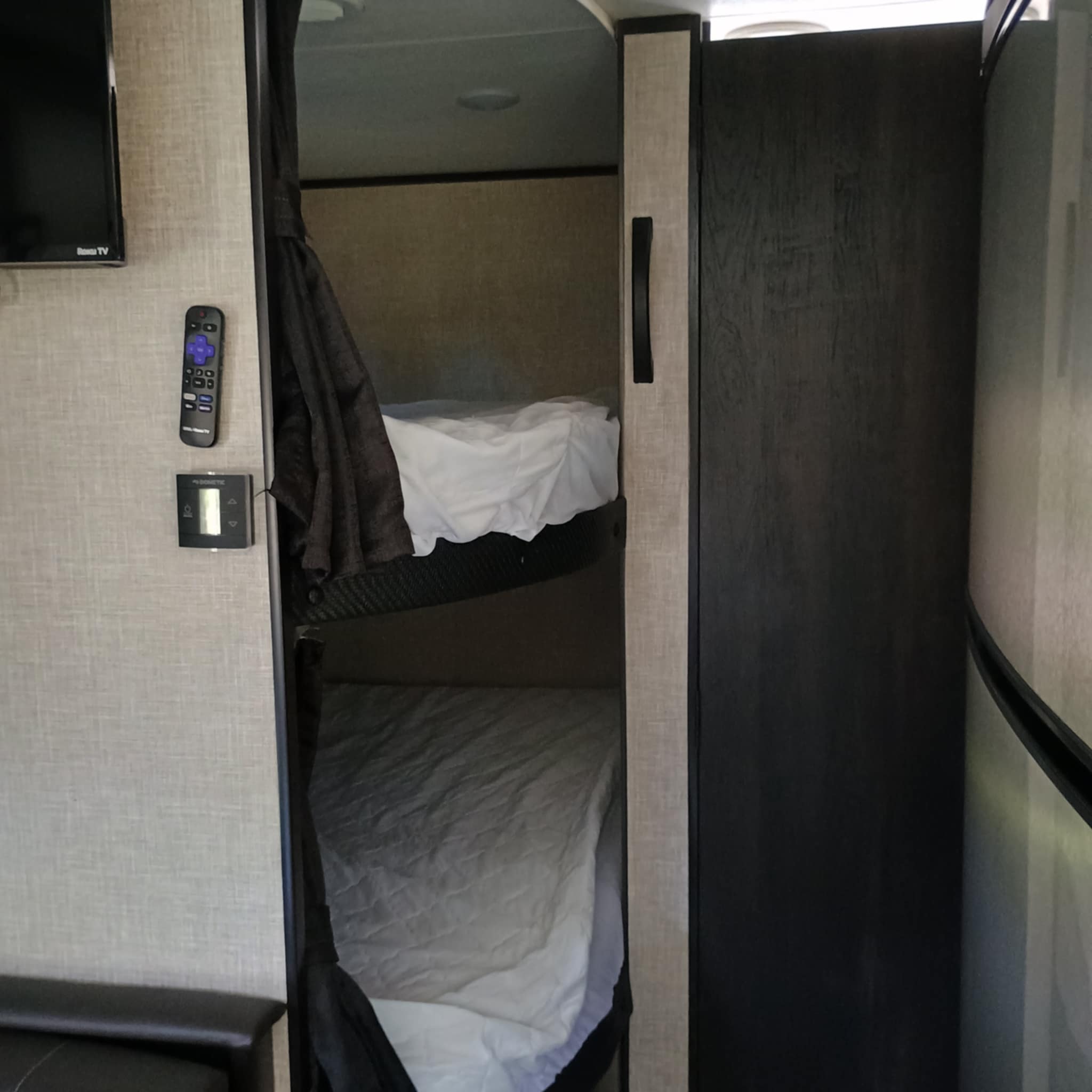 Cozy RV rental bunk beds with white bedding, a Roku TV, and Dometic climate control for your comfort.. Jayco Jay Flight SLX 2022
