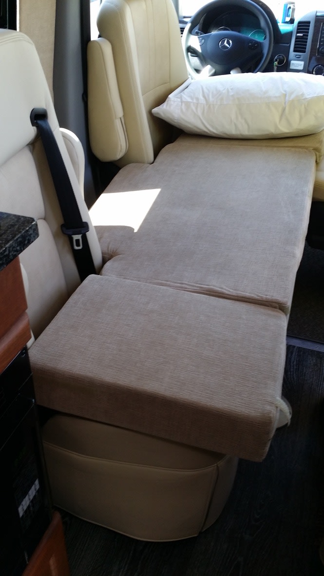 RV rental interior: tan seat converts to bed, white pillow by Mercedes driver's seat. Ready for your road trip!. Roadtrek RS Adventurous XL 2017