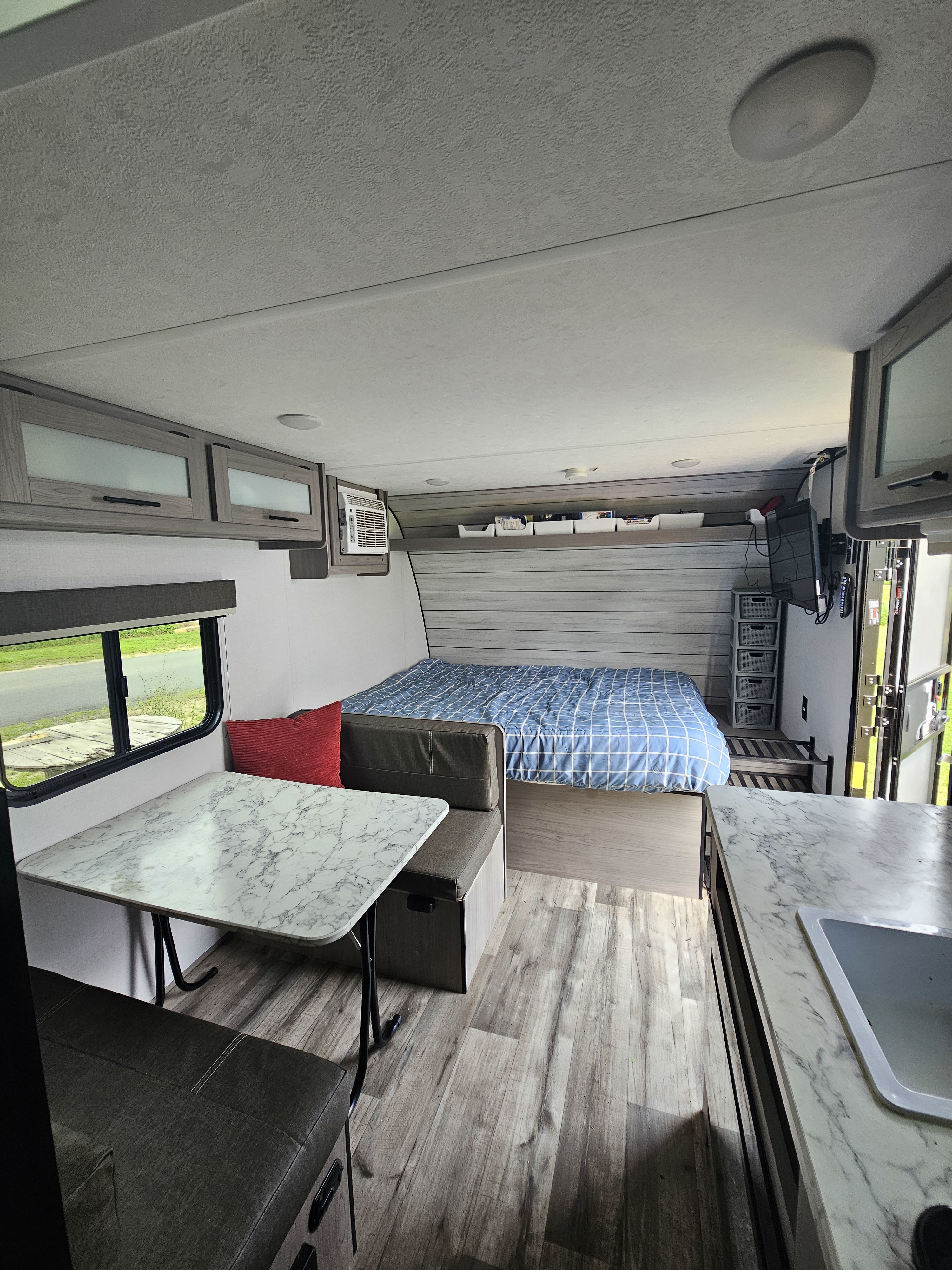 RV rental: The well-appointed interior features a bed, dining area, compact kitchen, and overhead storage.. Coleman 17b 2024