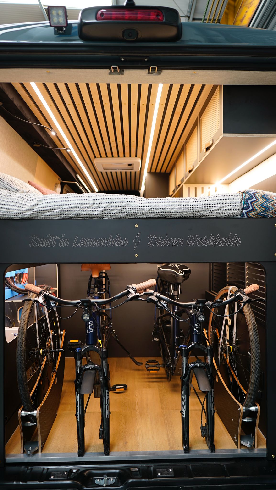 Inside an RV rental: cozy bunk bed over clever storage for two bikes, perfect for road trip adventures.. Citroen Relay L4H2 2025