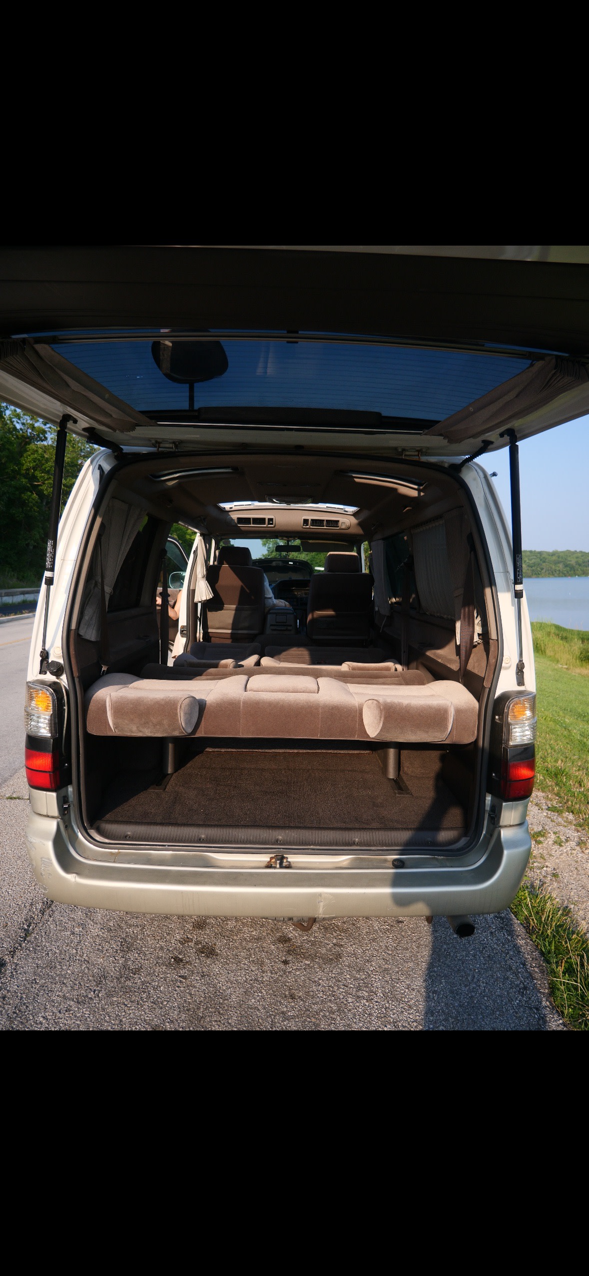 Spacious van interior with convertible seating, perfect for an rv rental adventure near the lake.. Toyota Hiace 4WD 1997