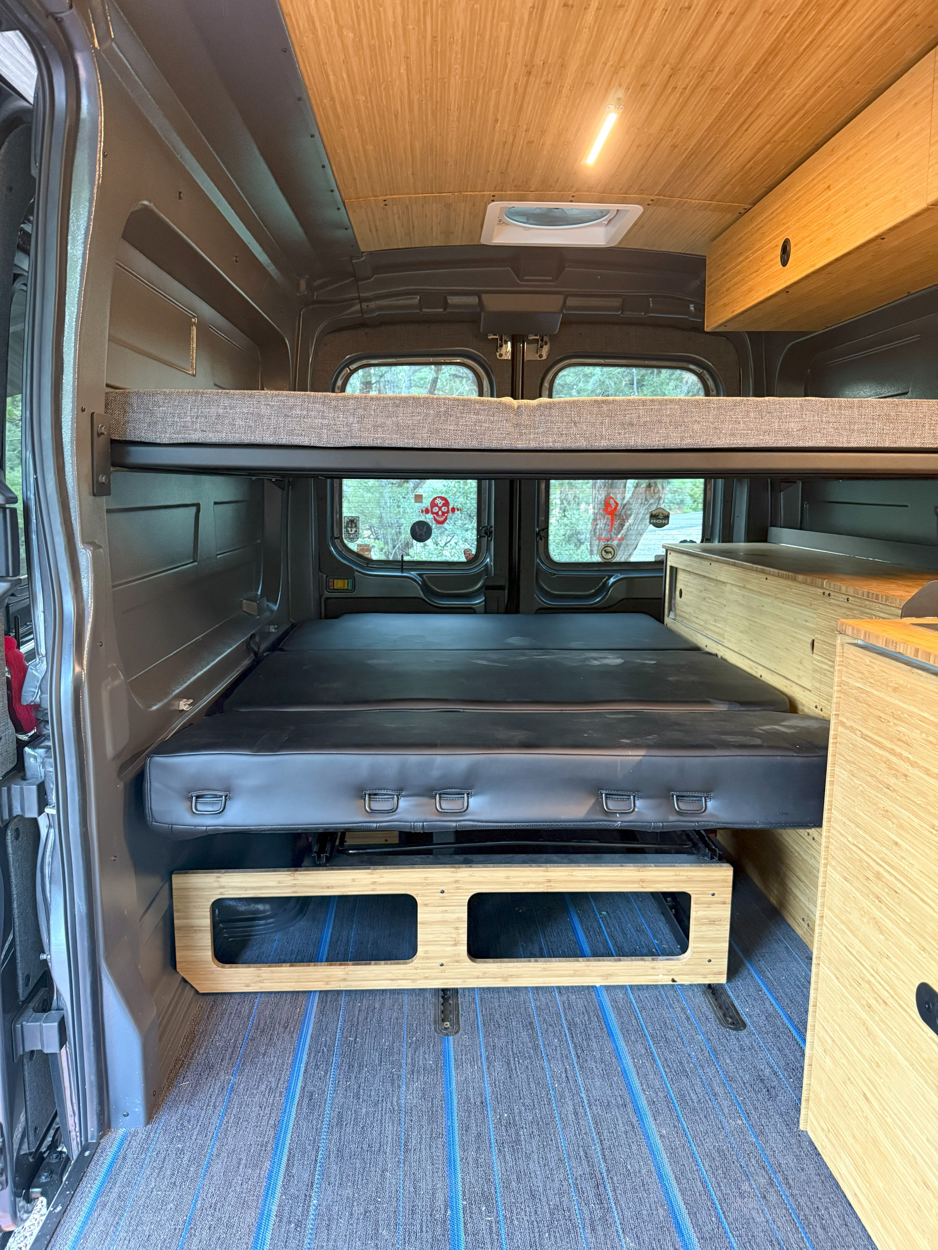 Inside this RV rental: versatile bunk beds, lower modular bed, bamboo ceiling, and built-in storage. Ready for adventure!. Ford Transit Custom 2024
