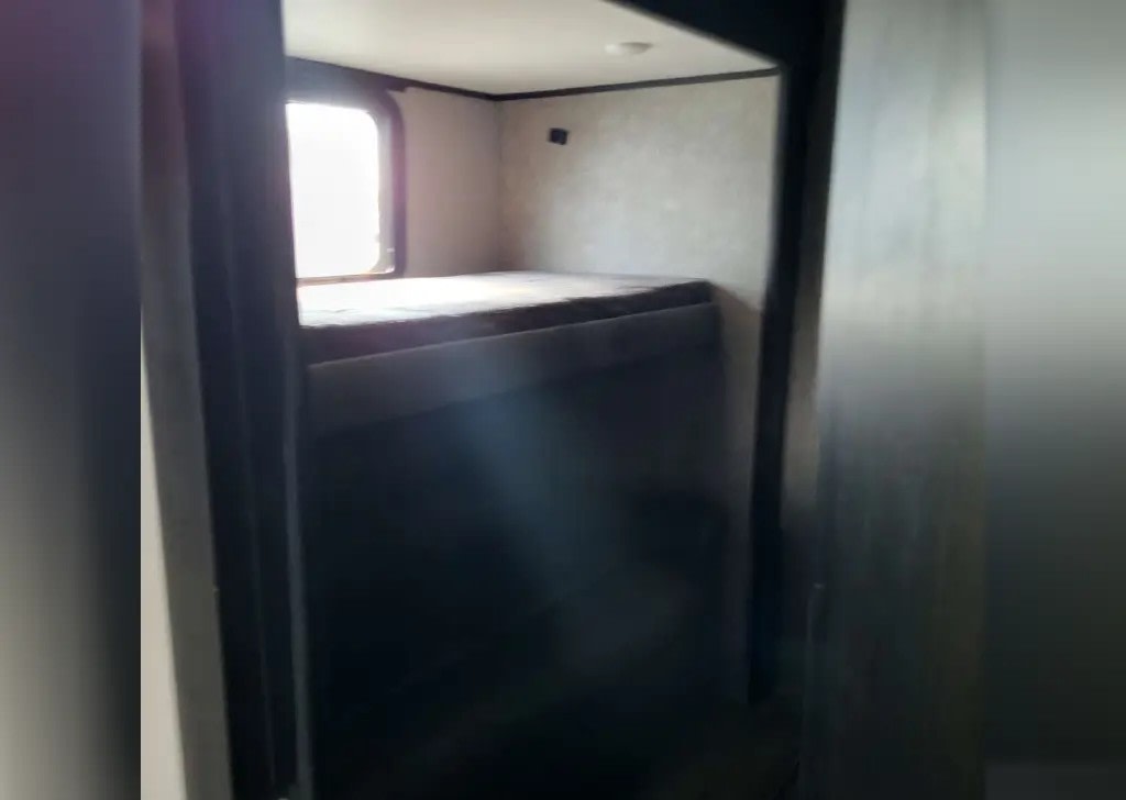 RV rental: Interior view of a bunk room featuring two stacked bunk beds and a window for natural light.. Jayco Eagle 2021