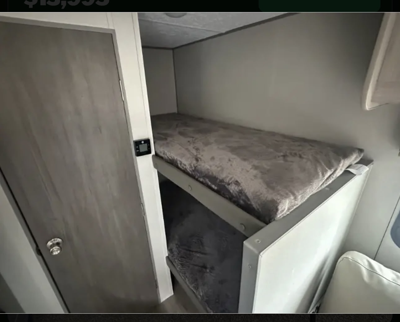 RV rental bunk beds: a cozy, well-lit sleeping area in a modern camper interior, visible with controls on the wall.. Coachman Catalina 164BHX 2025