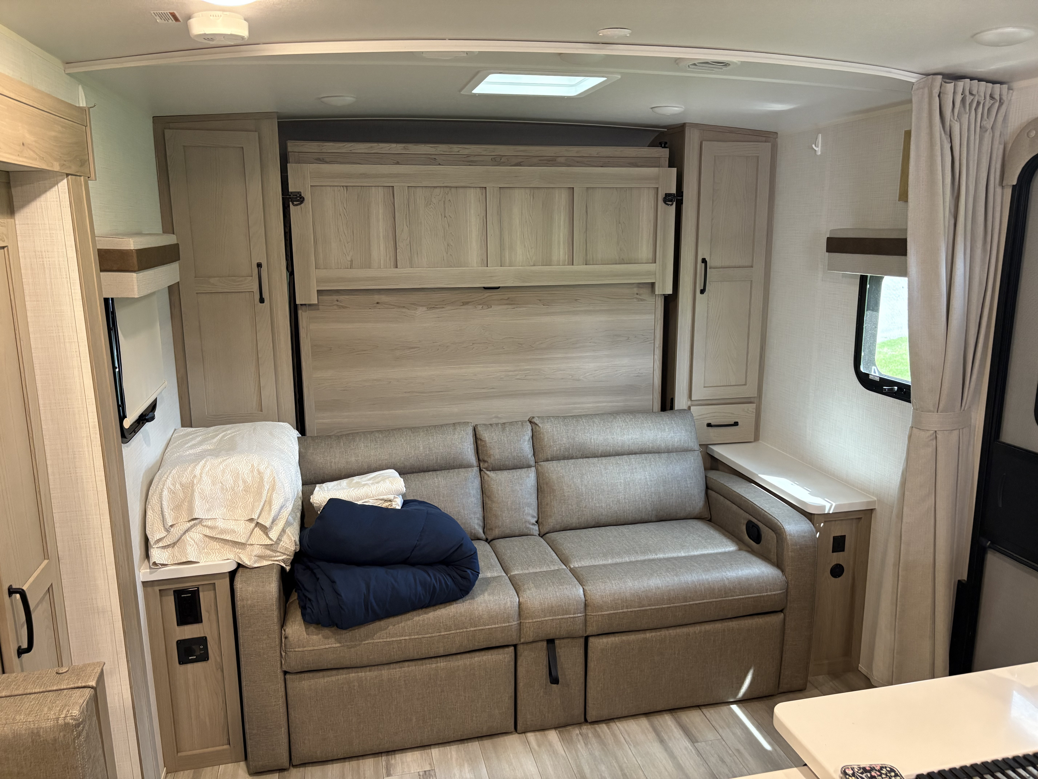 RV rental with a pull-out sofa and upright Murphy bed for flexible sleeping. Includes built-in cabinets & window. Ideal for travel.. Forest River Rockwood Mini Lite 2024