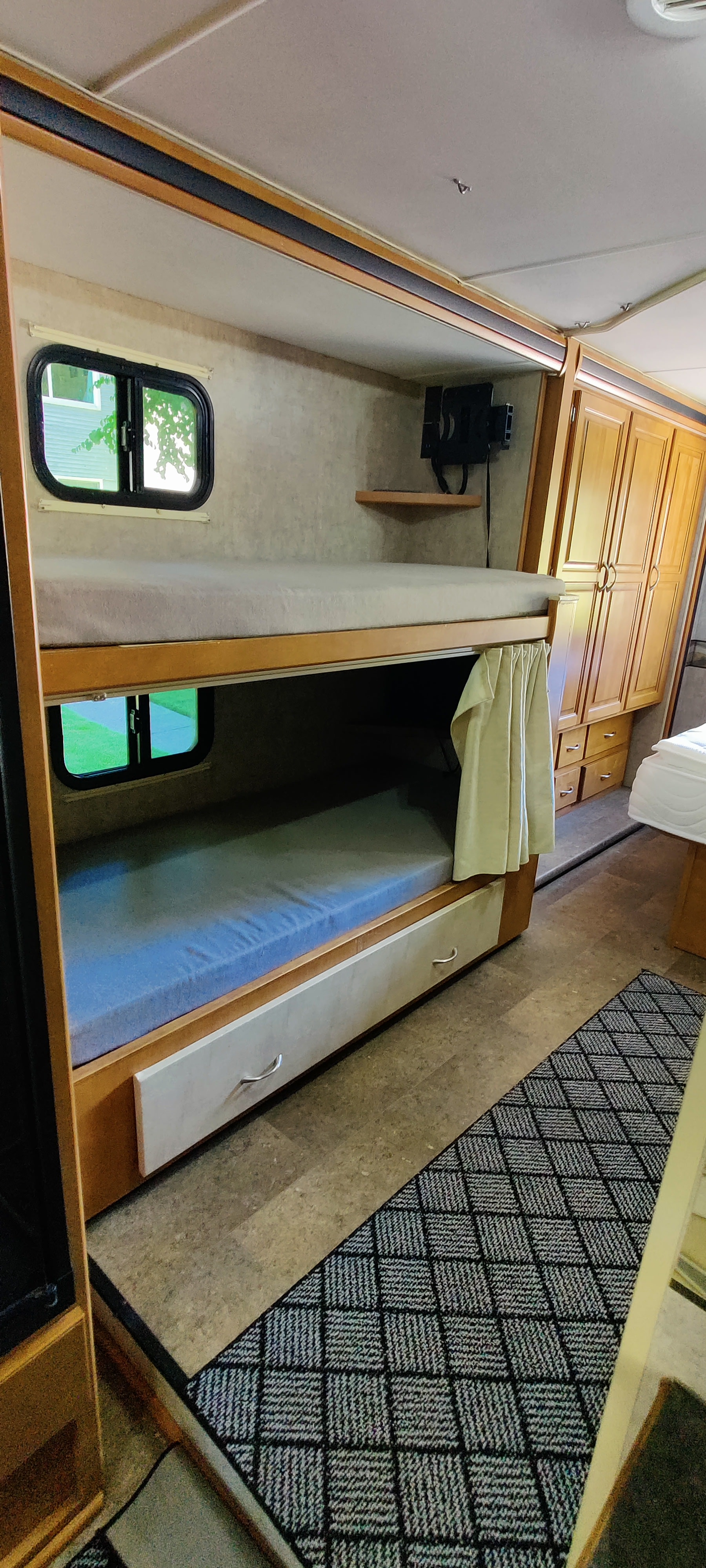 RV rental's bunk beds offer comfortable sleeping with windows, storage drawers, and a privacy curtain.. Itasca Spirit 2014