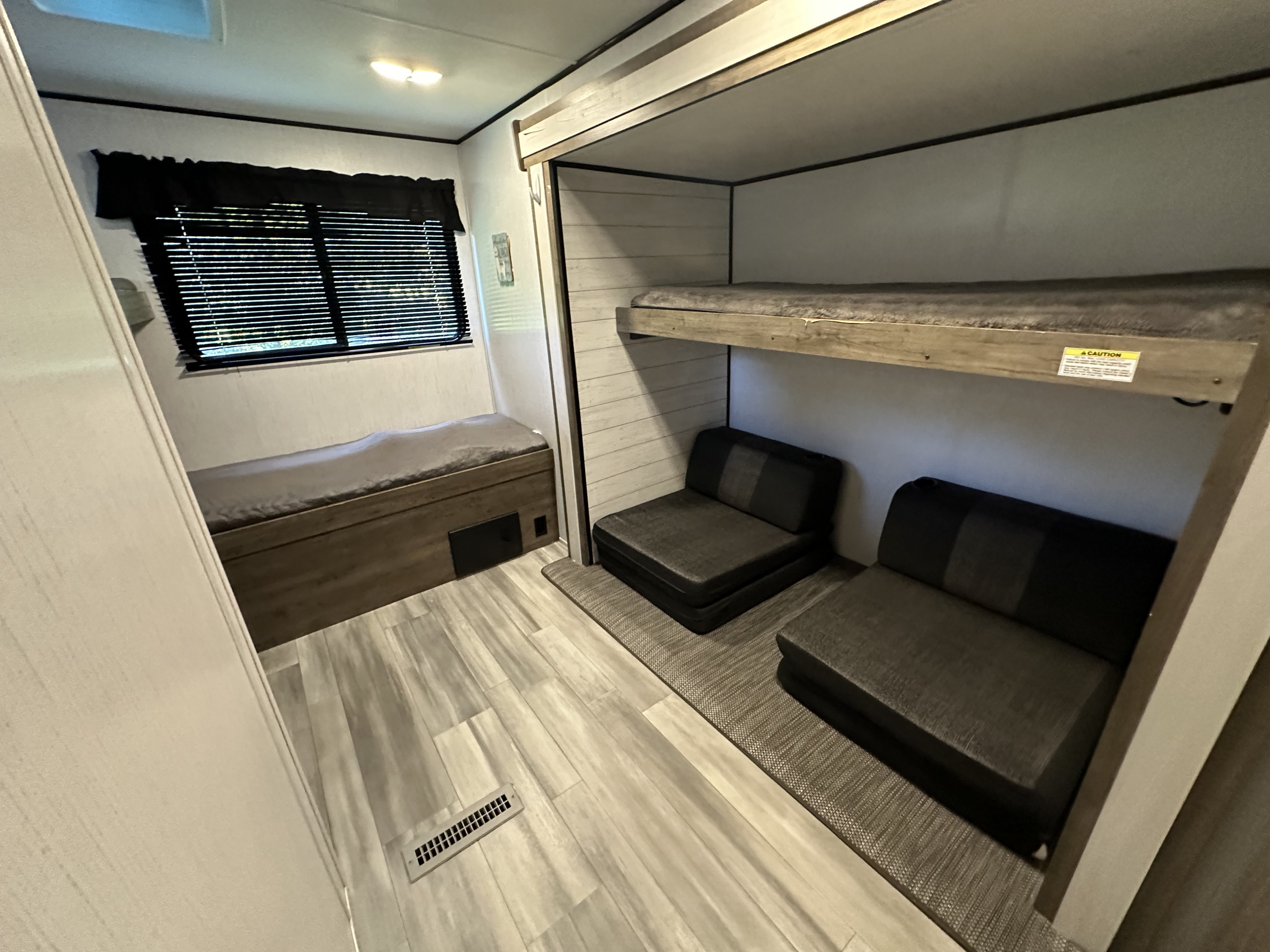 Explore this RV rental's versatile interior: two bunk beds, two convertible lounge chairs, and a comfy bench bed with storage.. Heartland RVs Pioneer 2022