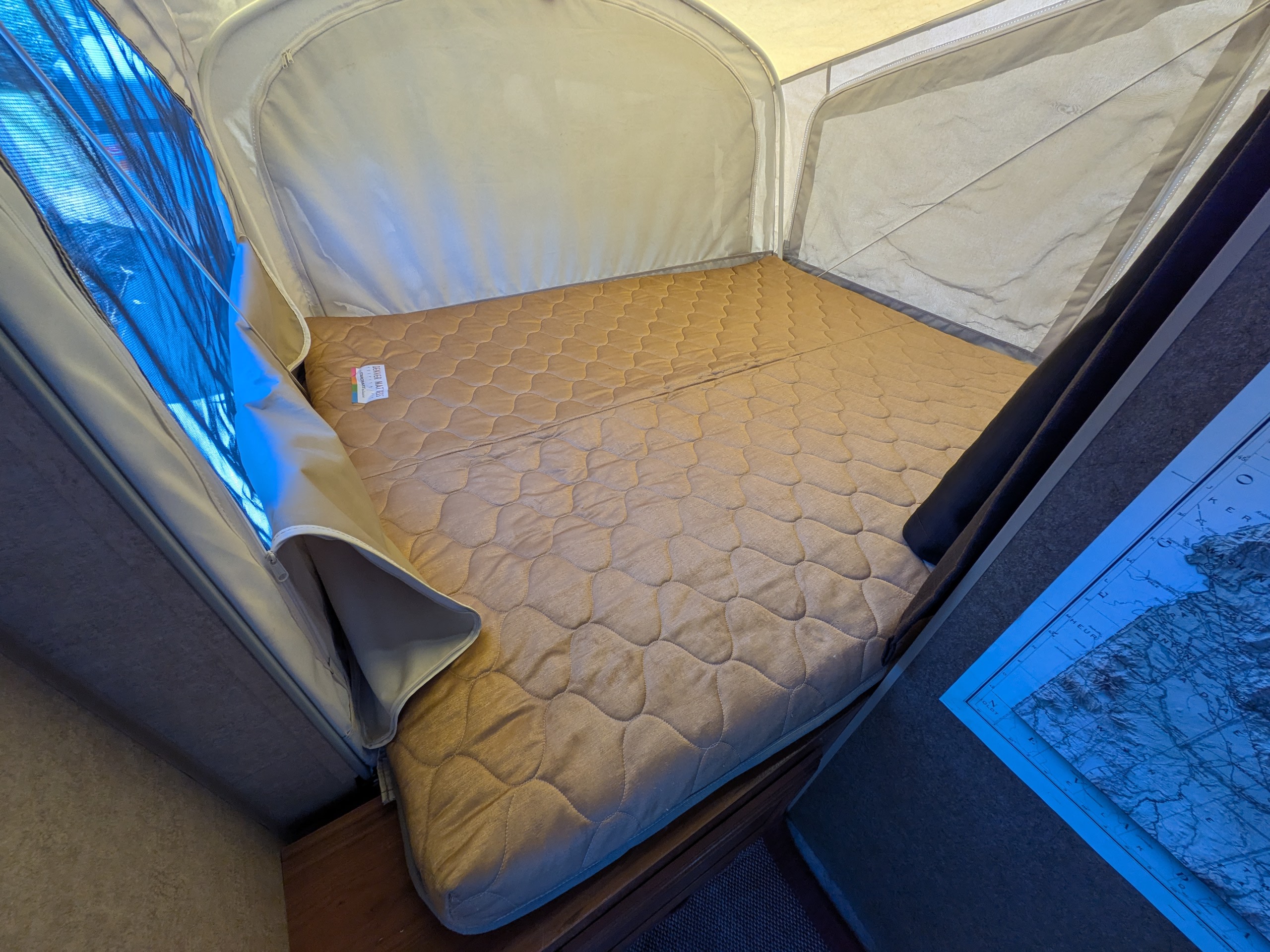 Cozy sleeping area in an RV rental, featuring a comfortable quilted mattress and mesh windows for ventilation, ready for adventure.. Starcraft AR-One 2015