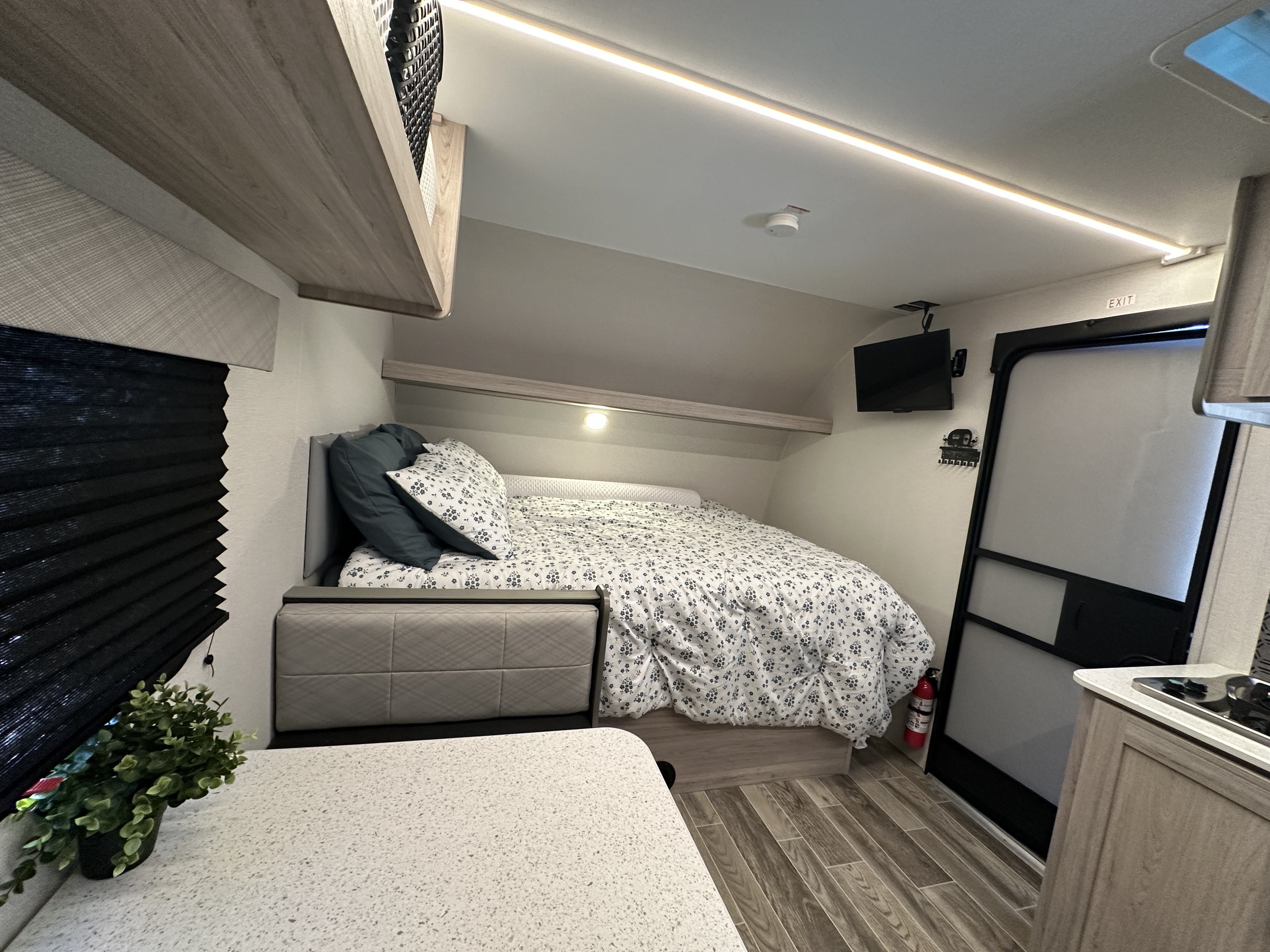 Cozy RV rental interior: featuring a spacious bed, window blinds, TV, fire extinguisher, and integrated ceiling lights.. Heartland Mallard 17bhl 2025