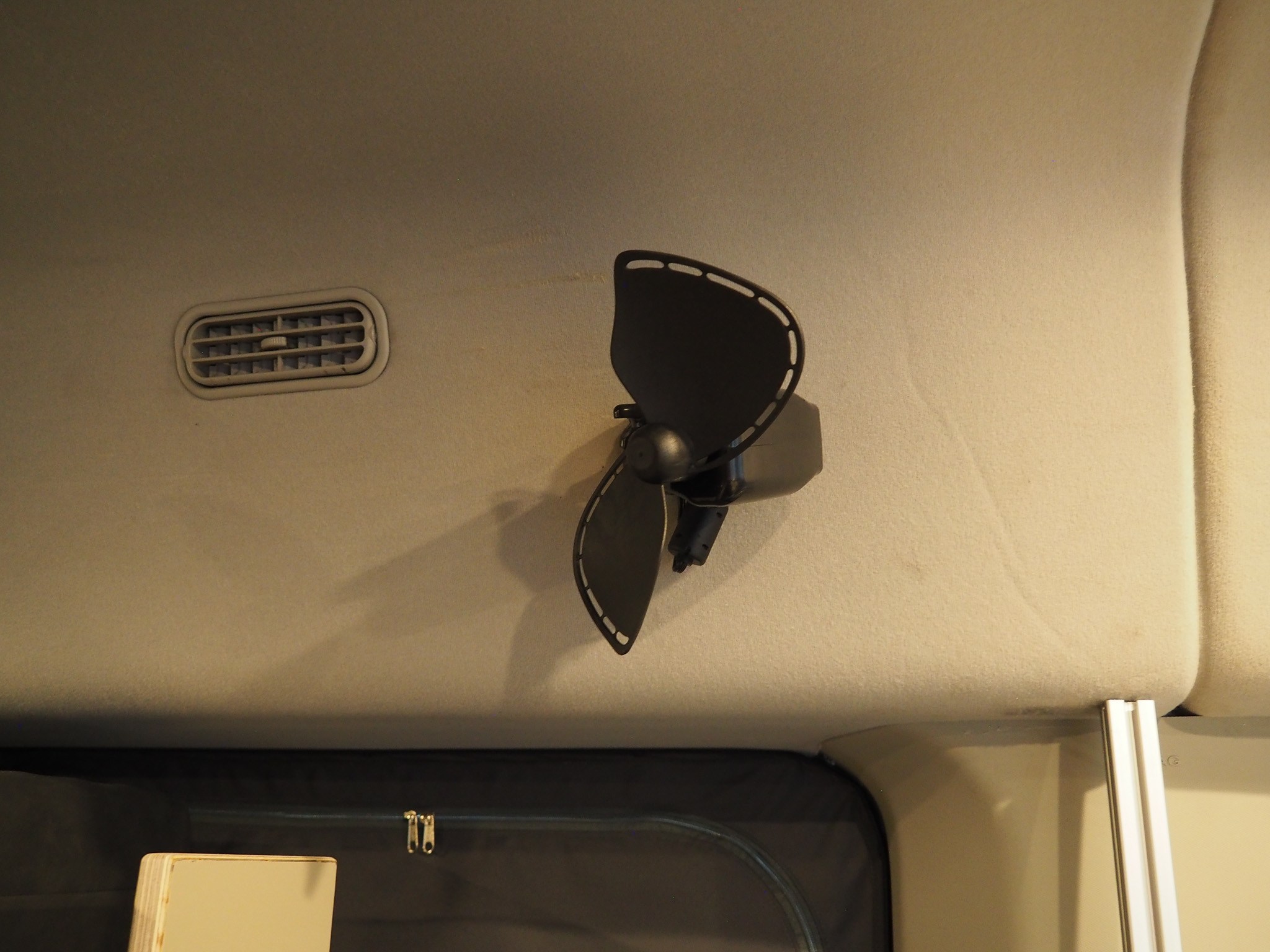 Stay cool in your rv rental: ceiling-mounted electric fan and air vent inside a camper van.. Ford Transit 2019