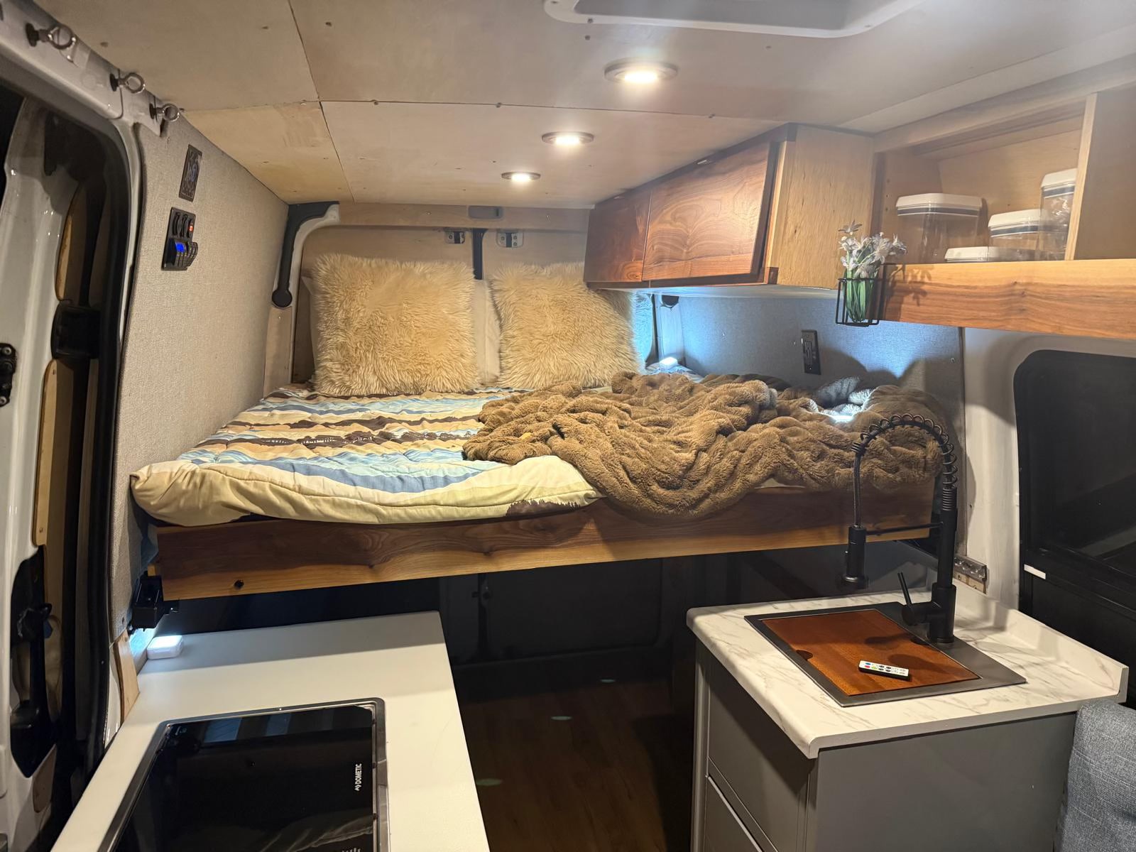 Experience van life! This RV rental features a cozy bed, modern kitchen, and clever storage for adventures.. Mercedes-Benz Sprinter 2014