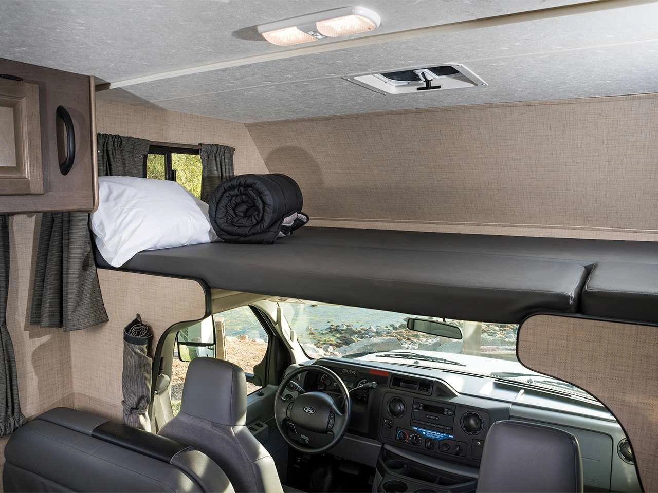 Step inside this RV rental featuring a comfy overhead bunk with pillow/sleeping bag, driver's cabin, & scenic view.. Thor Majestic 2018