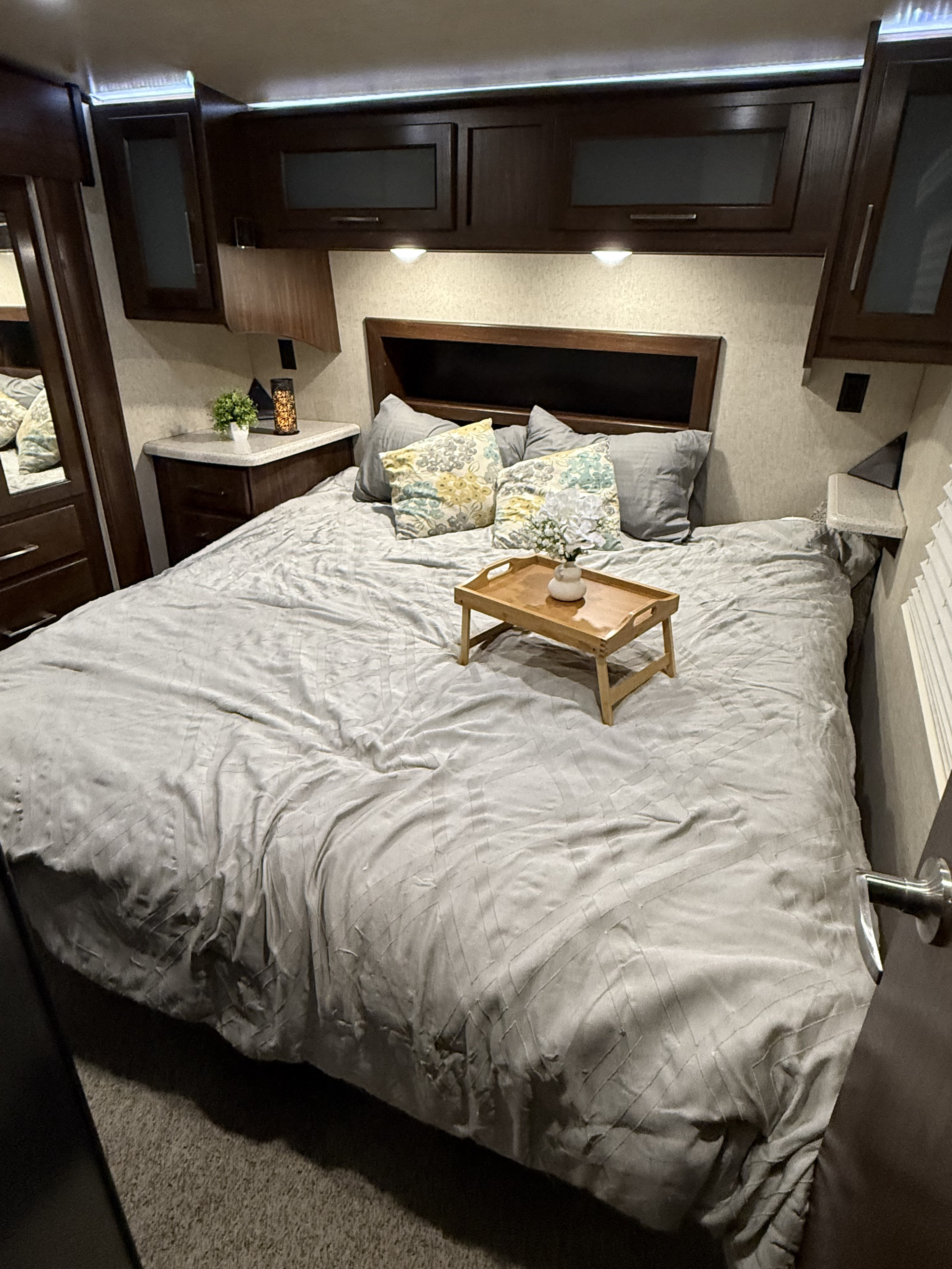 Cozy RV rental bedroom with comfortable bedding and ample storage, perfect for your next adventure.. Heartland RVs Cyclone Toy Hauler 2018