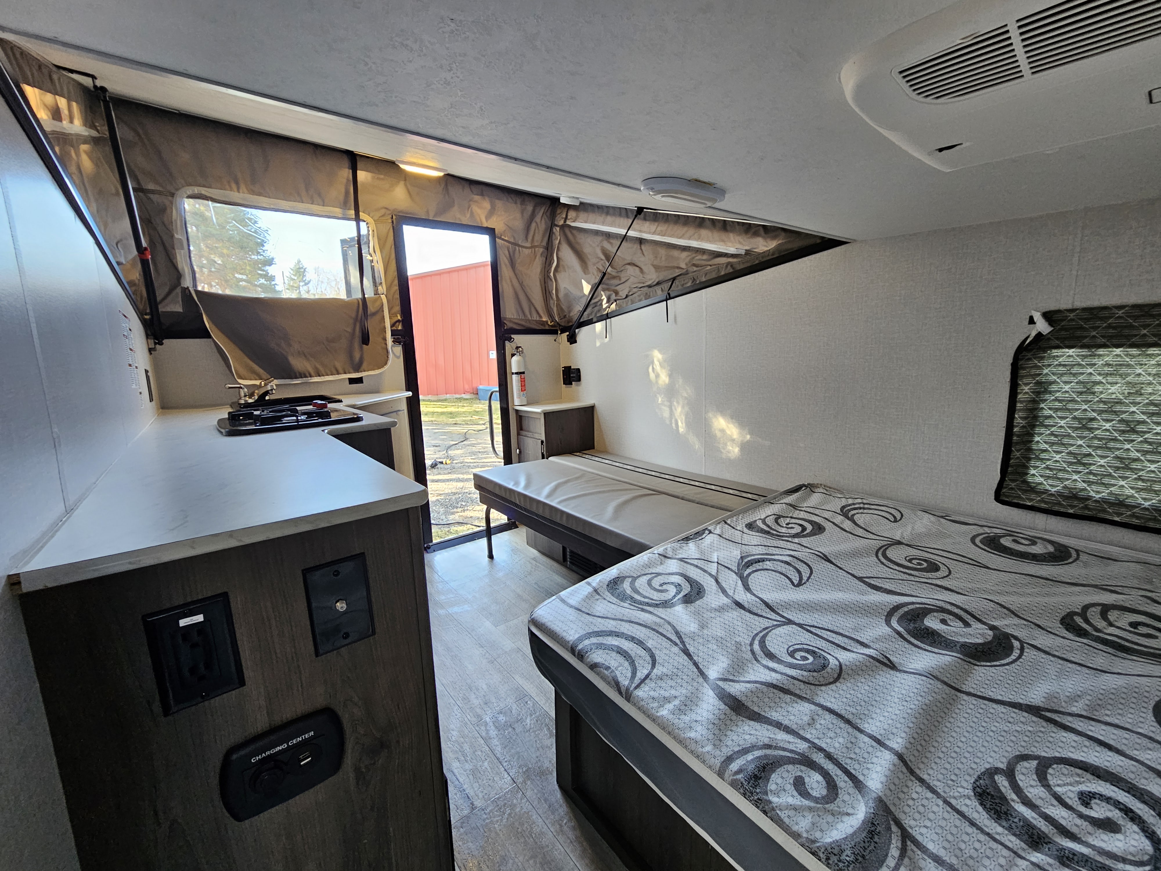 Spacious RV rental interior with kitchen, two beds, and pop-out tent sections, ready for adventure.. Forest River V-Cross 2022