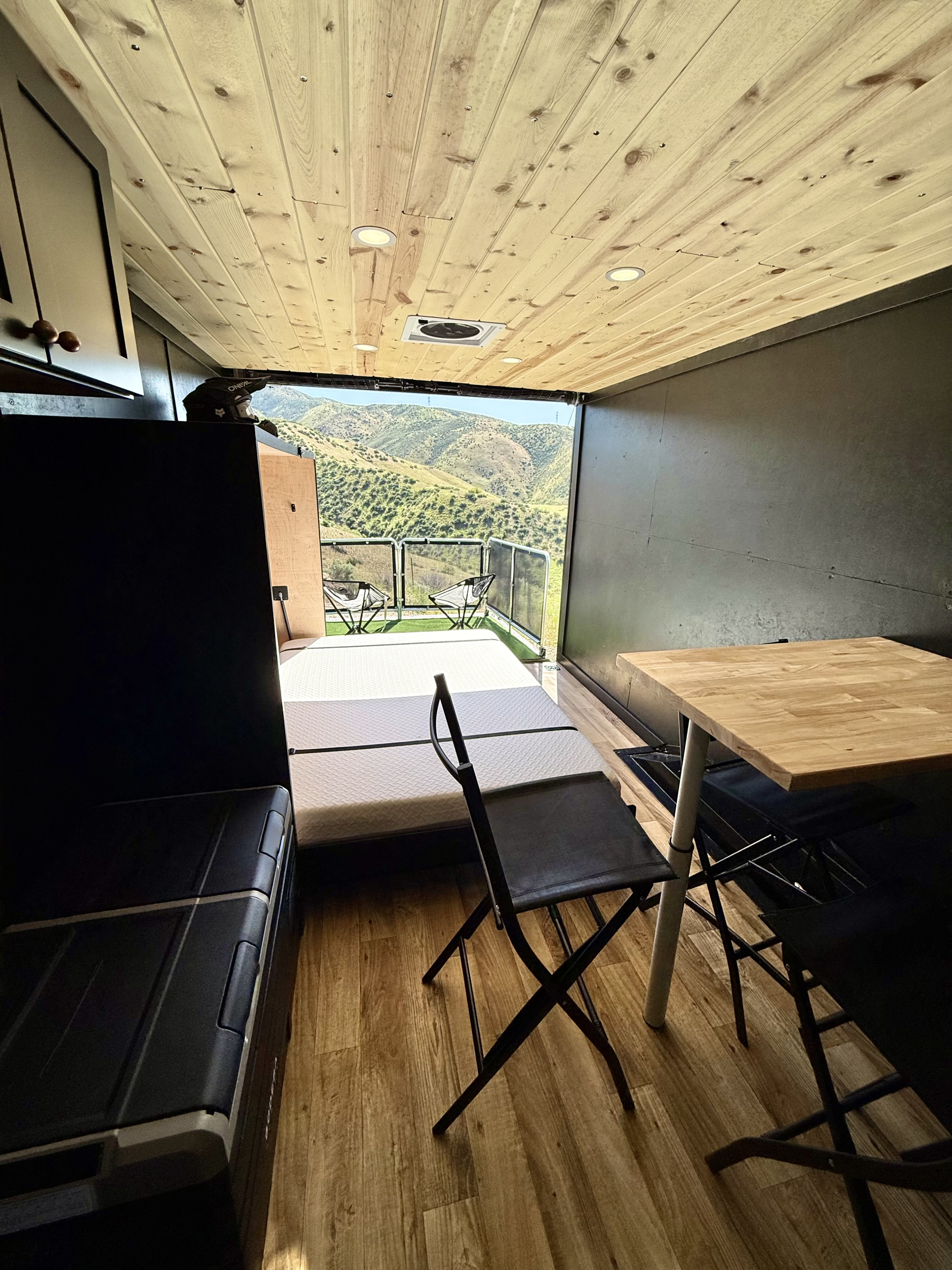 Experience nature with this RV rental! Interior features wood-paneled ceiling, comfy bed, and a patio with mountain views.. Idaho adventure vehicles Toy hauler 20 2025