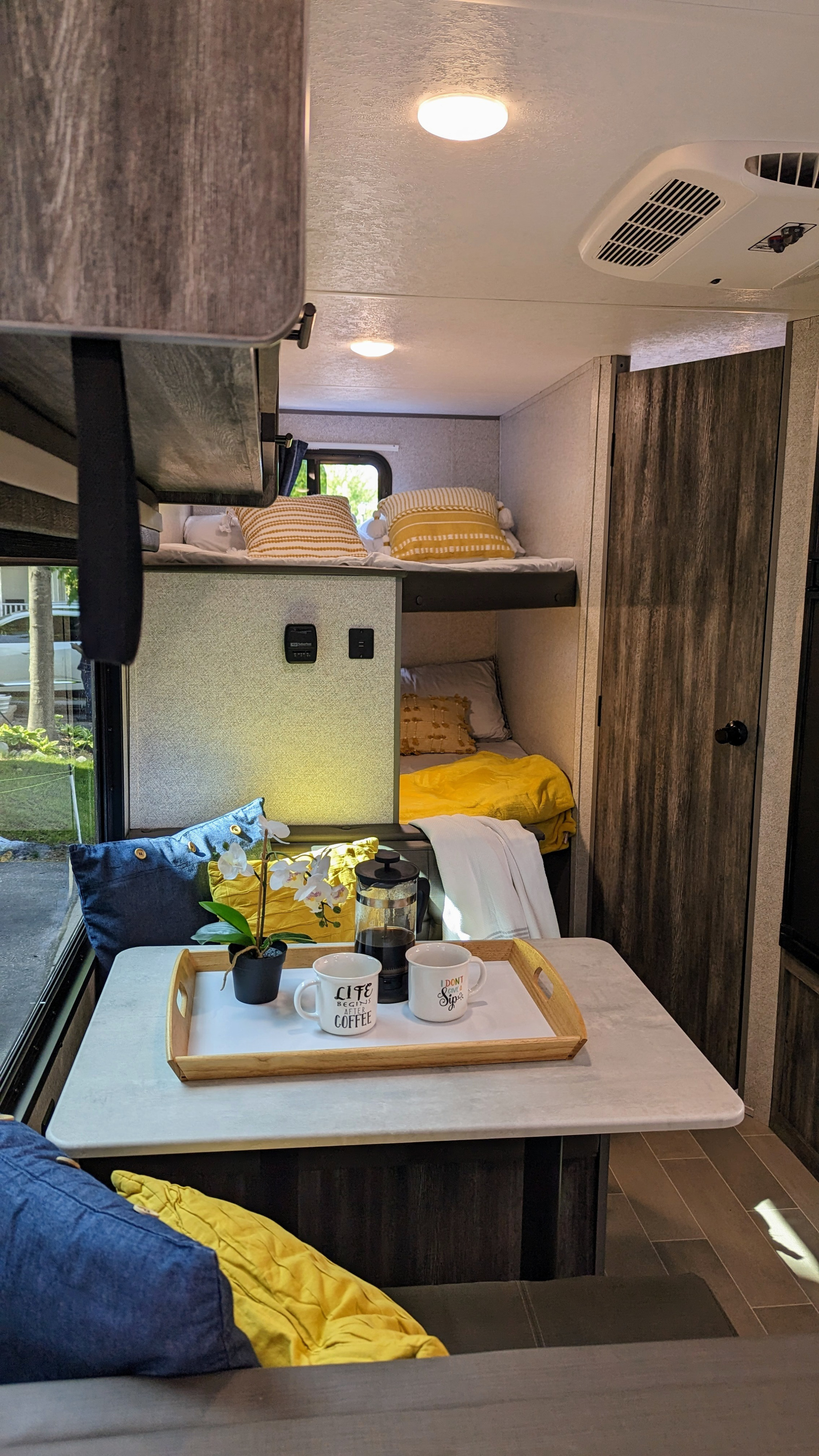 Cozy RV rental interior with a bright dinette coffee setup, bunk beds, and ample living space.. Forest River Wildwood FSX 2020