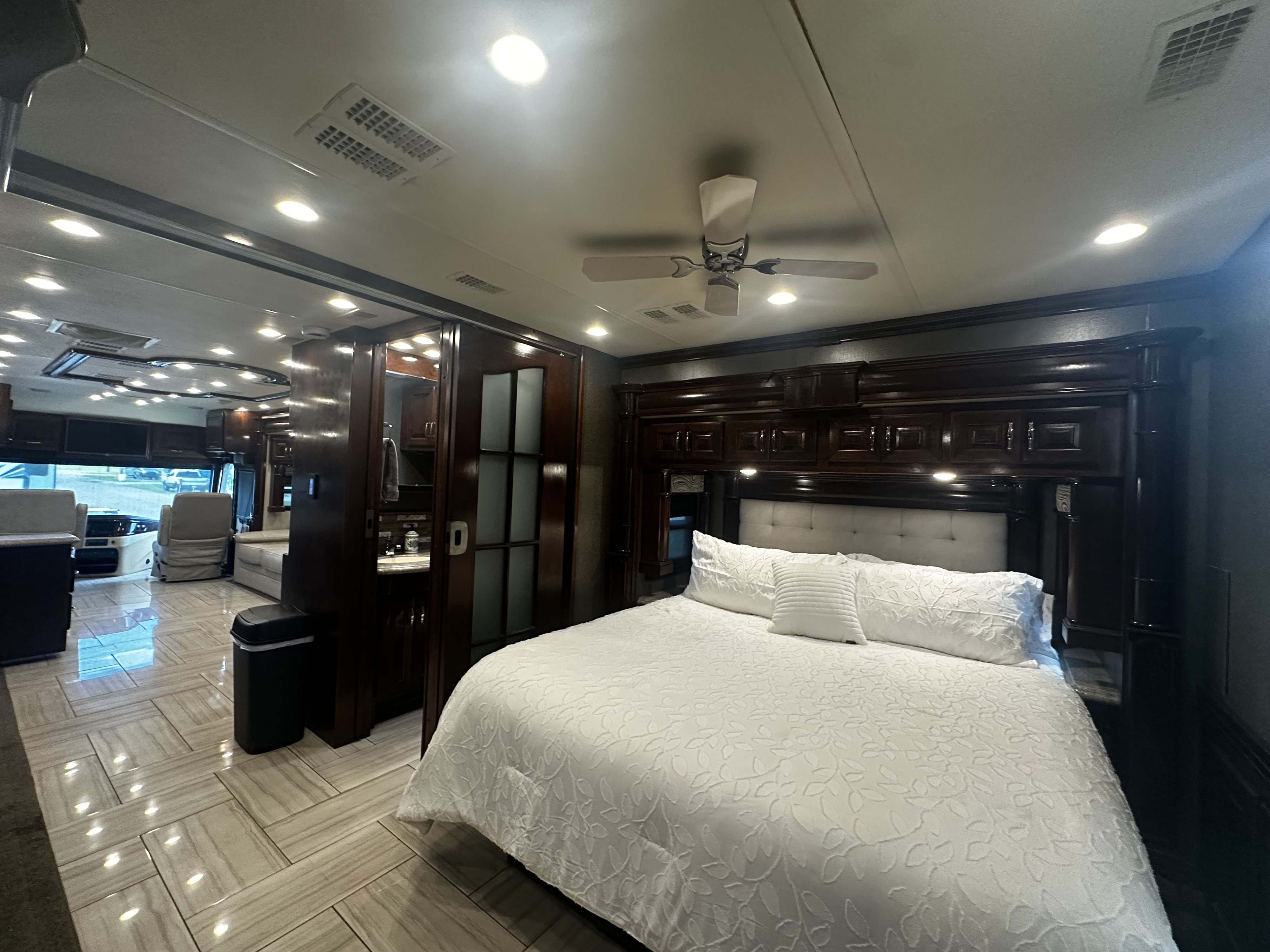 Plush bedroom and living area inside a luxurious motorhome RV rental, ideal for comfortable travel.. American Revolution American Revolution Motorhome 2017