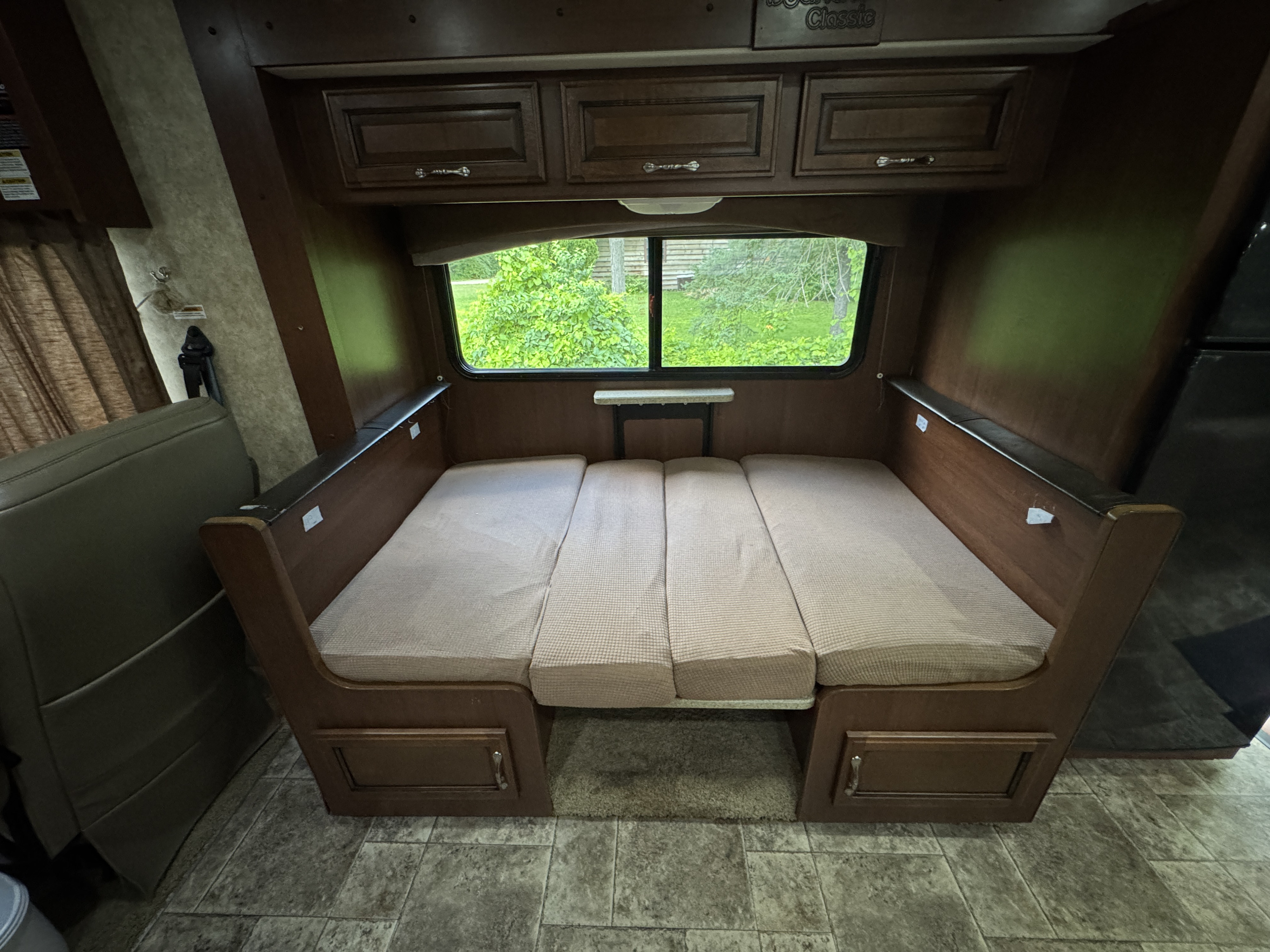 RV rental interior: dinette easily converts to a bed, offering a cozy sleeping space with scenic views.. Bounder Classic 2013