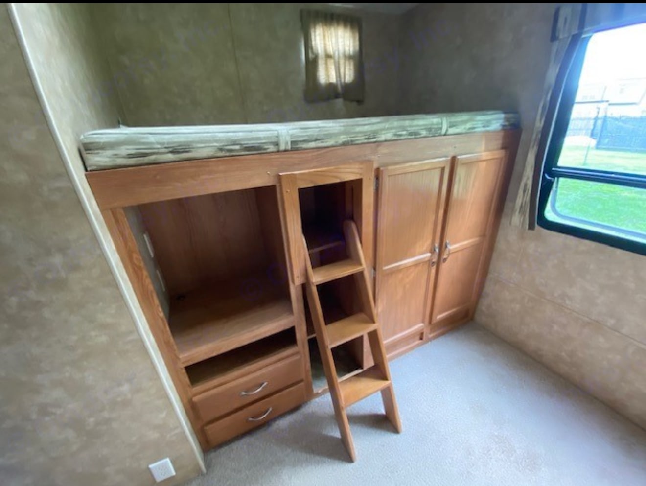 Explore this RV rental's cozy bunk bed area, complete with a ladder, ample storage, and a window for natural light.. Jayco Jay Flight G2 2009