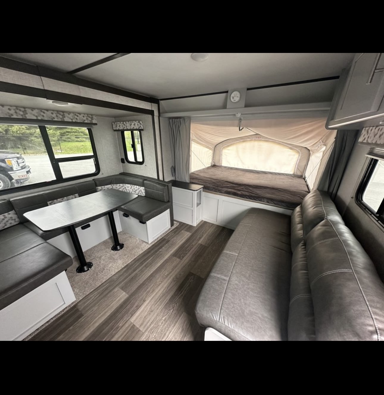 Spacious RV rental interior: a bright living space featuring a dinette, sofa, and cozy pop-out bed area.. Keystone RV Bullet Crossfire 2020