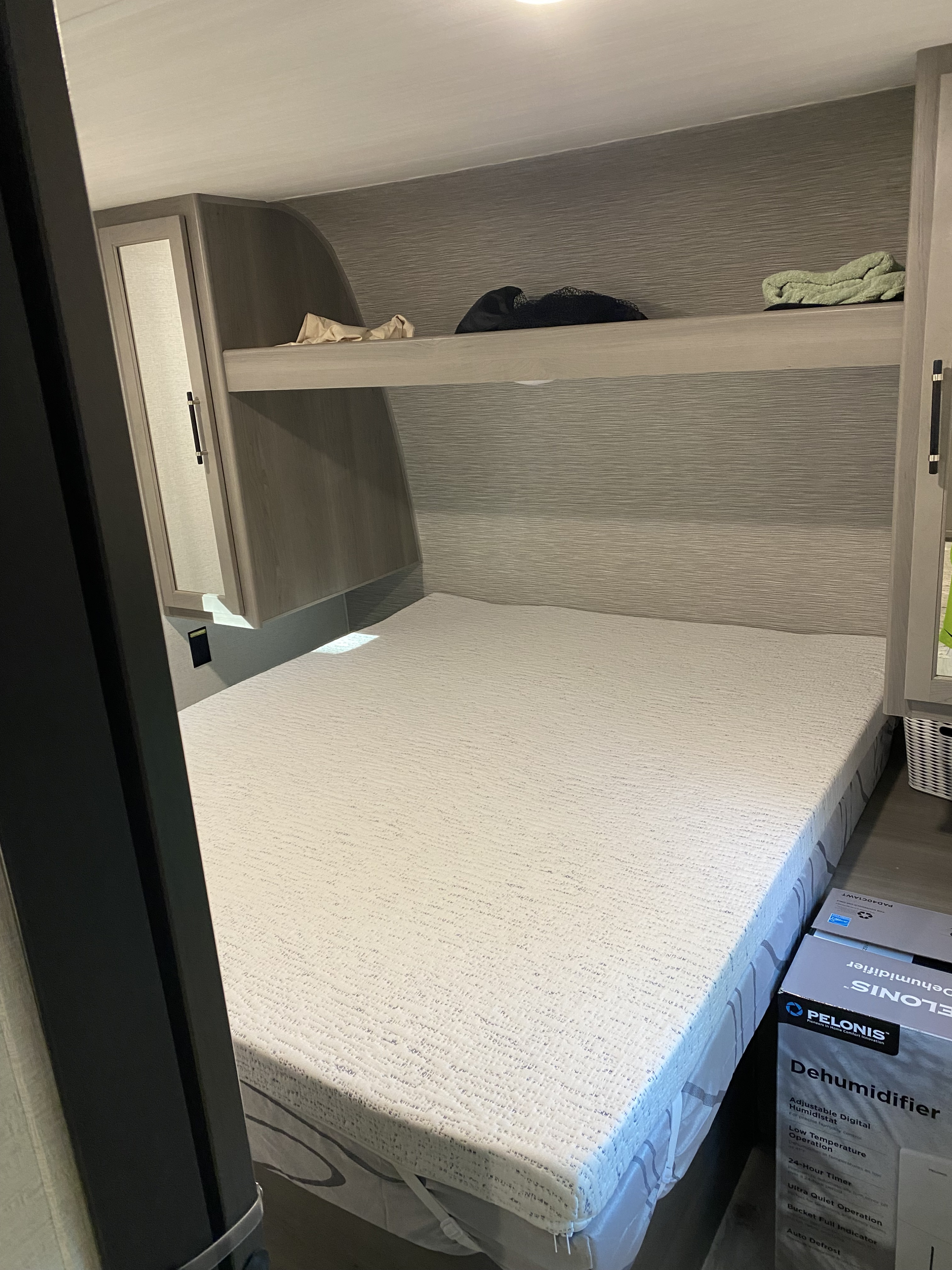 Enjoy comfort in this RV rental bedroom! Features include a clean bed, overhead storage, and a dehumidifier for a pleasant stay.. Keystone 291BR 2025
