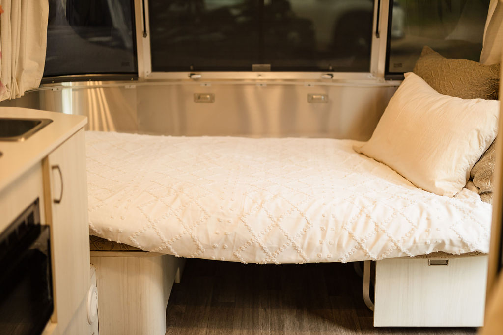 Cozy Airstream RV rental bedroom with comfortable bed and sleek interior.. Airstream Bambi 2022