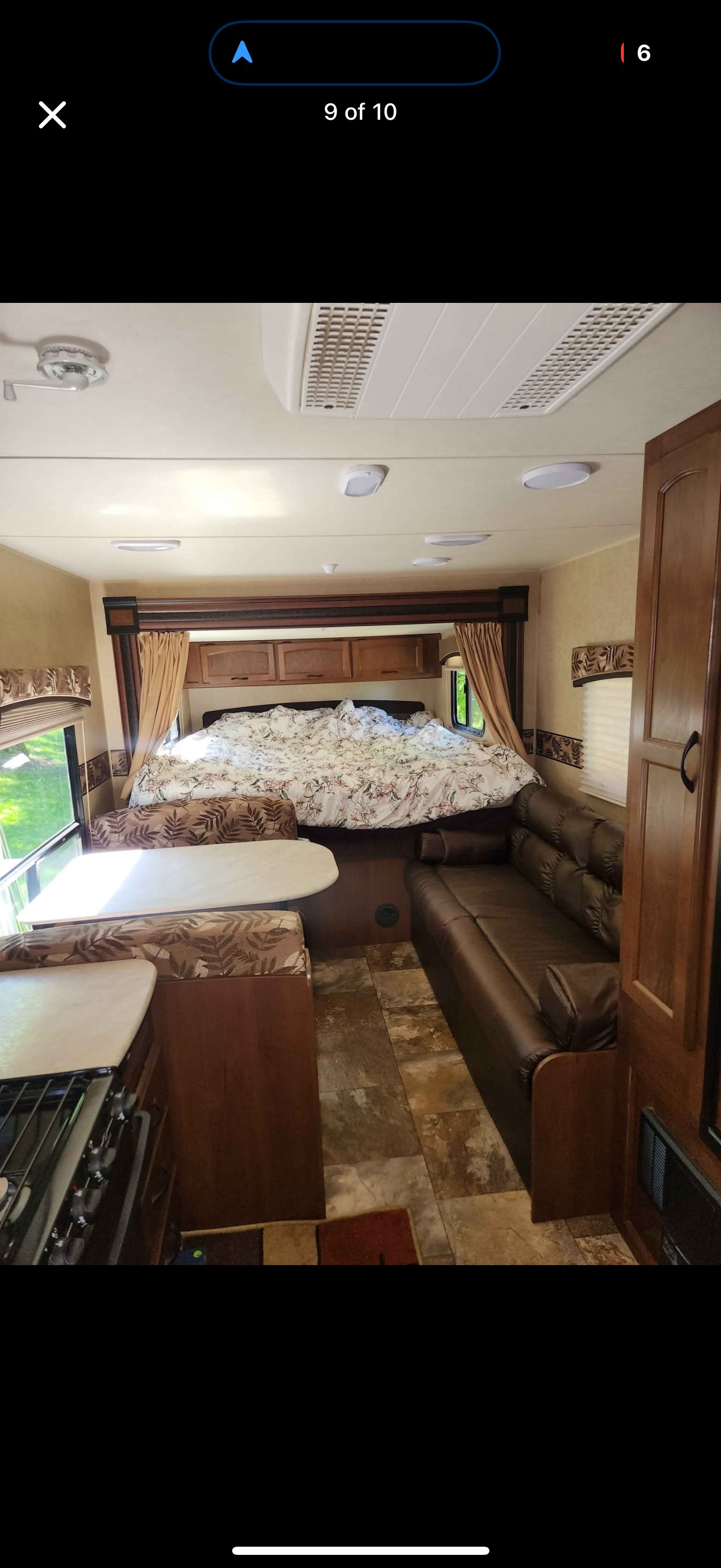 Spacious RV rental interior featuring a cozy bed, dinette, sofa, and kitchen area for comfortable travel.. Jayco Jay Feather Ultra Lite 2014