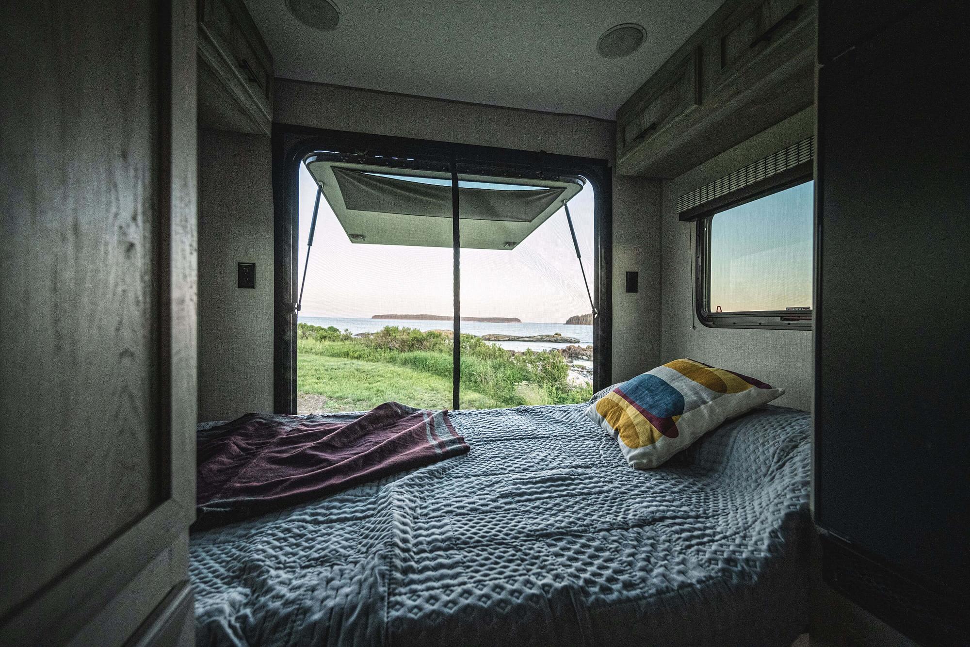 Relax in your RV rental with stunning coastal views. This cozy bedroom offers a perfect escape for travel.. KZ Escape Hatch 2022