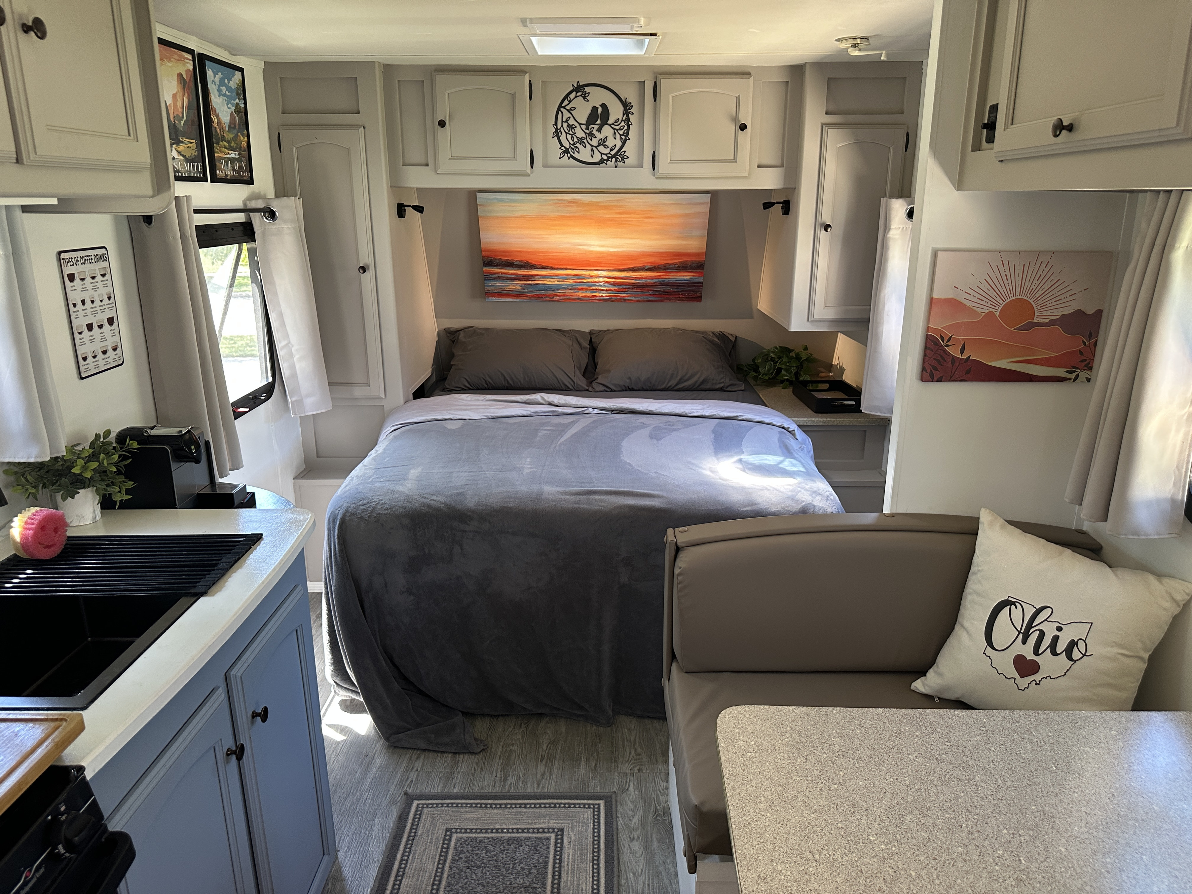 Inside a modern RV rental, featuring a cozy bedroom, functional kitchen with coffee, and a dinette. Ready for adventure!. Gulf Stream Stream Lite Sport 2011