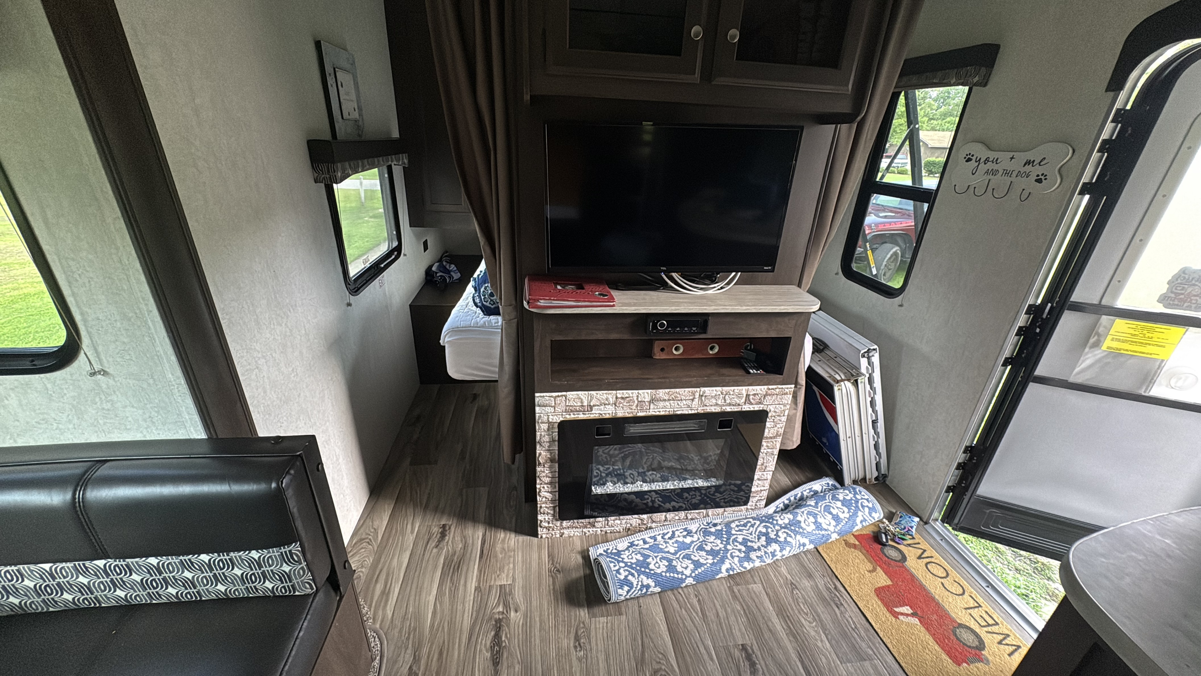 View inside an RV rental: living area with TV, faux fireplace, and bedroom beyond. Ready for your next adventure.. Starcraft Autumn Ridge Outfitter 2018