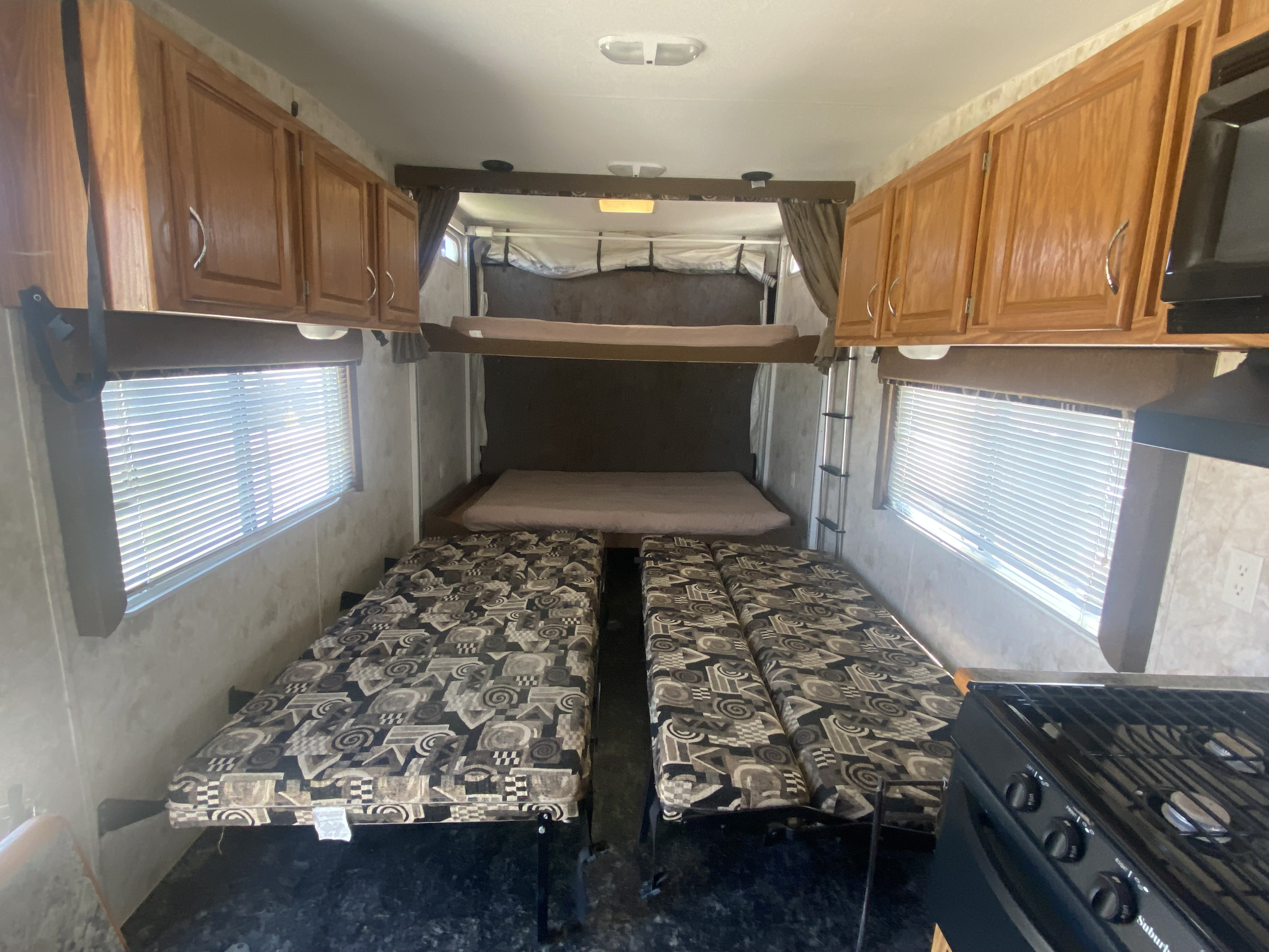This RV rental interior features convertible seating, bunk beds, kitchen area, and storage cabinets for your trip.. Eclipse Recreational Vehicles Attitude 2006